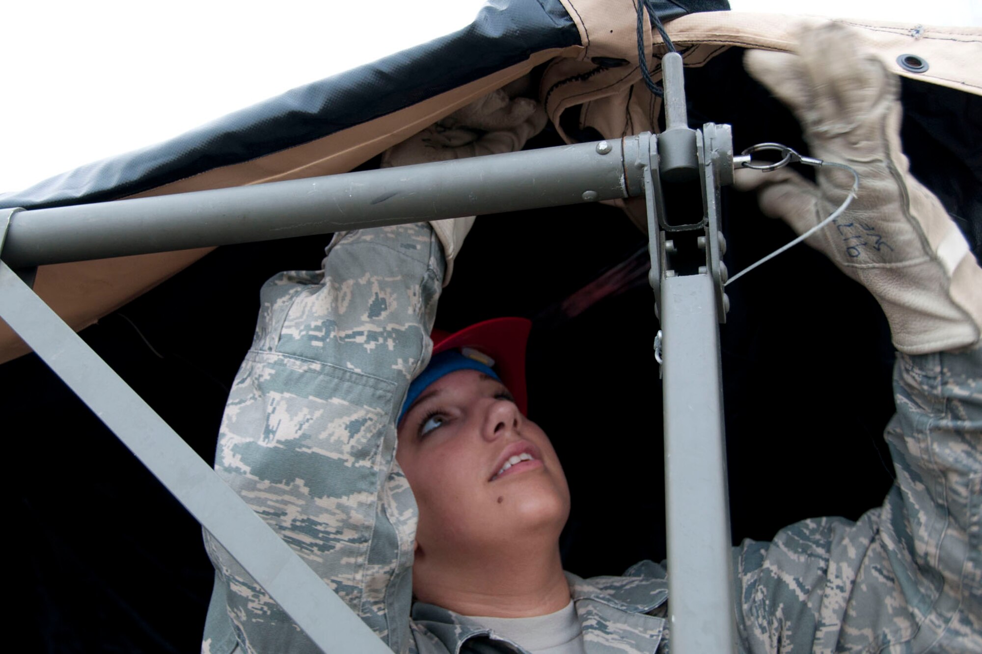 Airman Brooke Schenck, 307th Services Squadron Morale, Welfare, Recreation and Service specialist, makes adjustment on a tent pole joint March 31, 2012, at Barksdale Air Force Base, La., during a practice session for the John L. Hennessy Award competition.   Air Force food service operations throughout the world take part in the annual competition, which is based on a number of factors, including field operations.  Judges for the competition are expected to arrive during the summer.  (U.S. Air Force photo by Staff Sgt. Ted Daigle/Released)