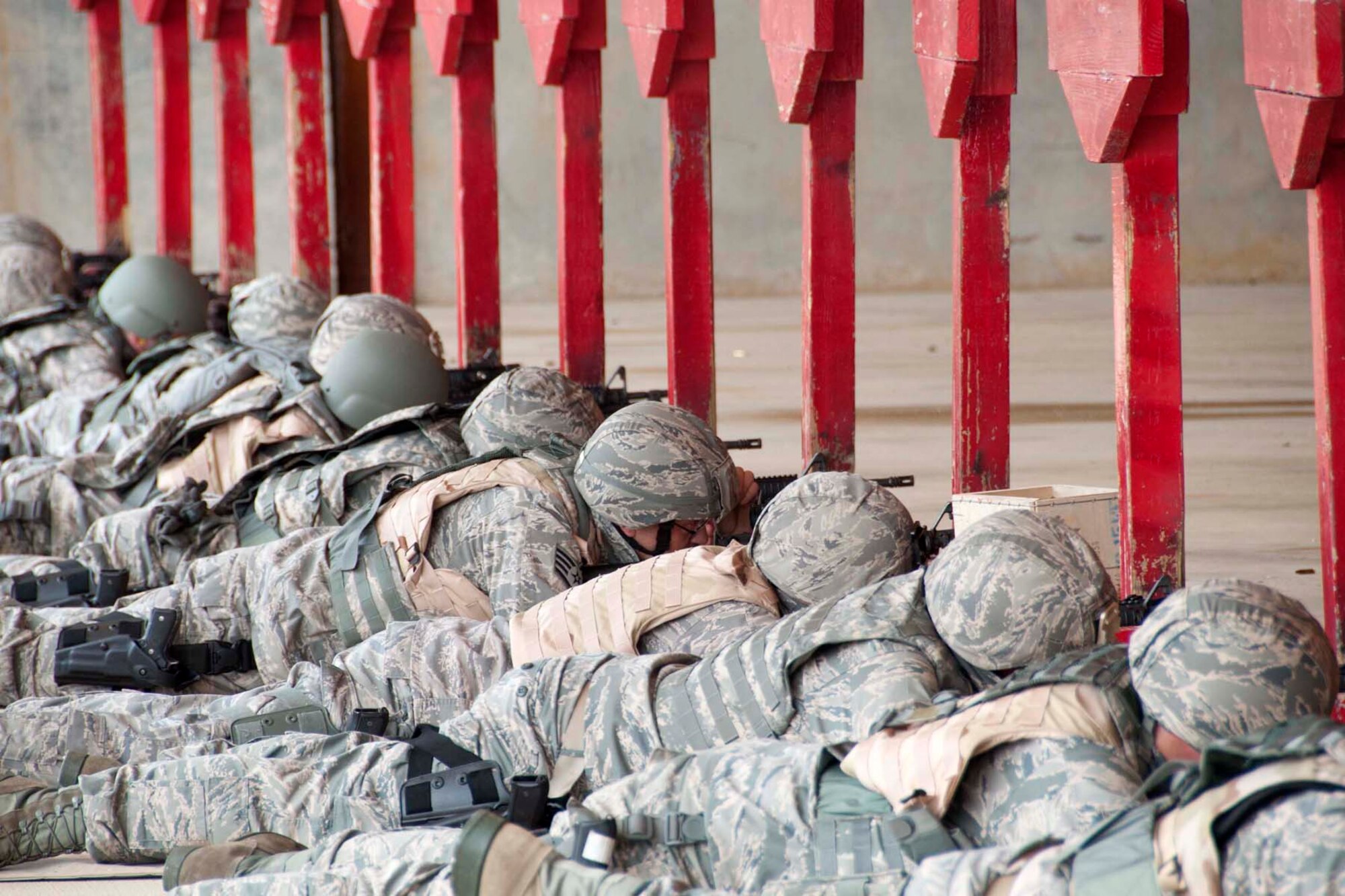 Members of the 307th Security Forces Squadron train in on targets downrange during a live fire immediate action exercise March 31, 2012 at Barksdale Air Force Base.  Airmen are now required to practice weapon clearing techniques while qualifying under live fire conditions as part of the new course of fire instituted this year.   Fake rounds placed in the magazine cause weapons to jam and force the Airmen to clear them, re-assess the target and resume firing.   (U.S. Air Force photo by Staff Sgt. Ted Daigle/Released)
