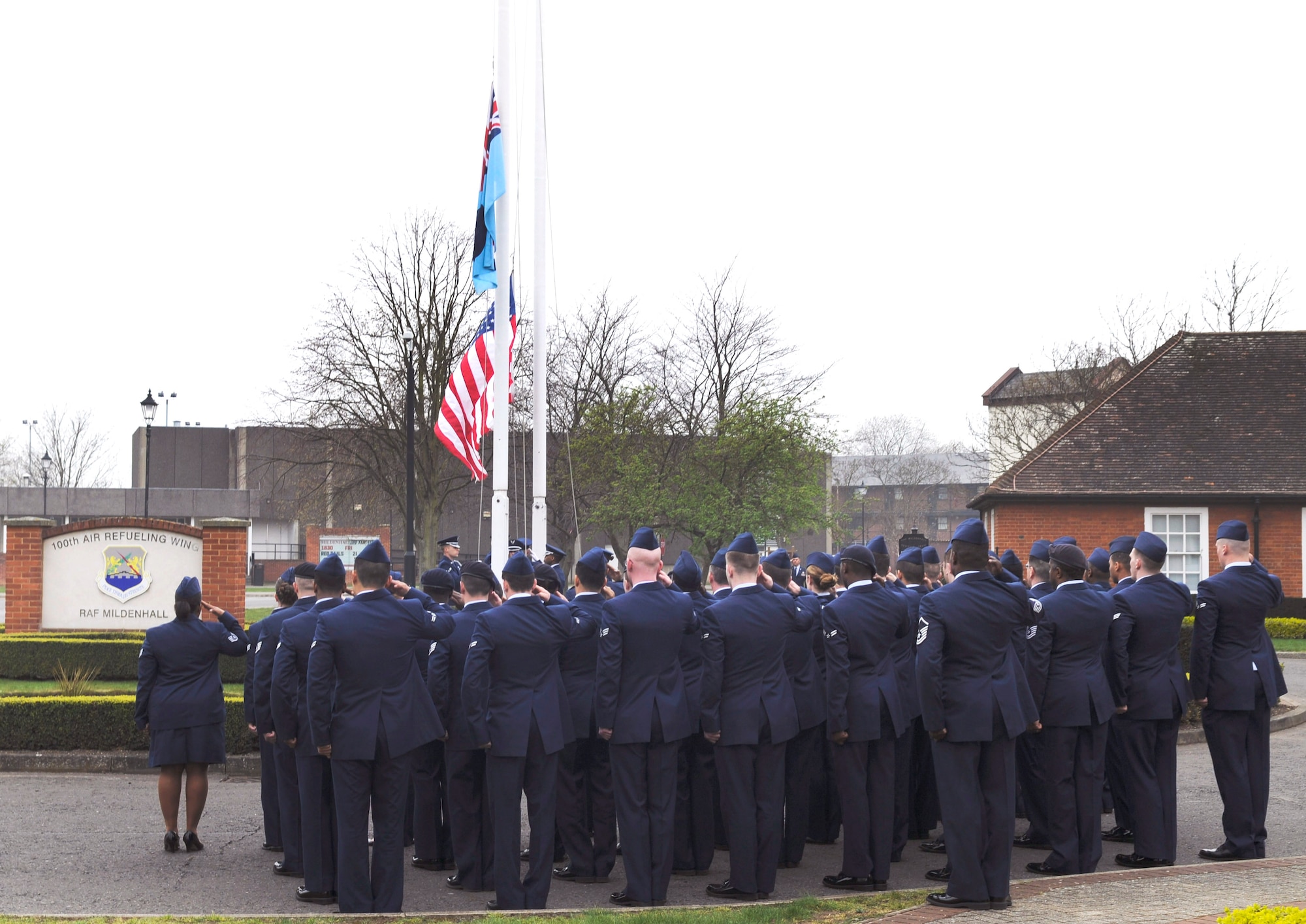 RAF MILDENHALL, England – Members of the 100th Mission Support Group salute as both the American and RAF insignia flags are lowered during a retreat ceremony here March 27, 2012.  The retreat ceremony was hosted by the 100th MSG and was the first to be held in 2012 here at RAF Mildenhall. (U.S. Air Force photo/Senior Airman Ethan Morgan)