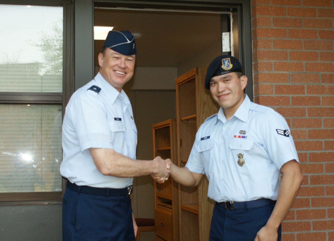 Brig. Gen. Darryl Burke, 82nd Training Wing commander, welcomes Airman 1st Class Isaac Fugon,82nd Security Forces Squadron, to the newly renovated building 527 dormitory during a dedication ceremony Apr. 2, 2012 at Sheppard Air Force Base, Texas.  The renovation project signficantly upgraded the building's air-conditioning system, along with new carpeting, paint and entry key system. (U.S. Air Force photo/Dan Hawkins)