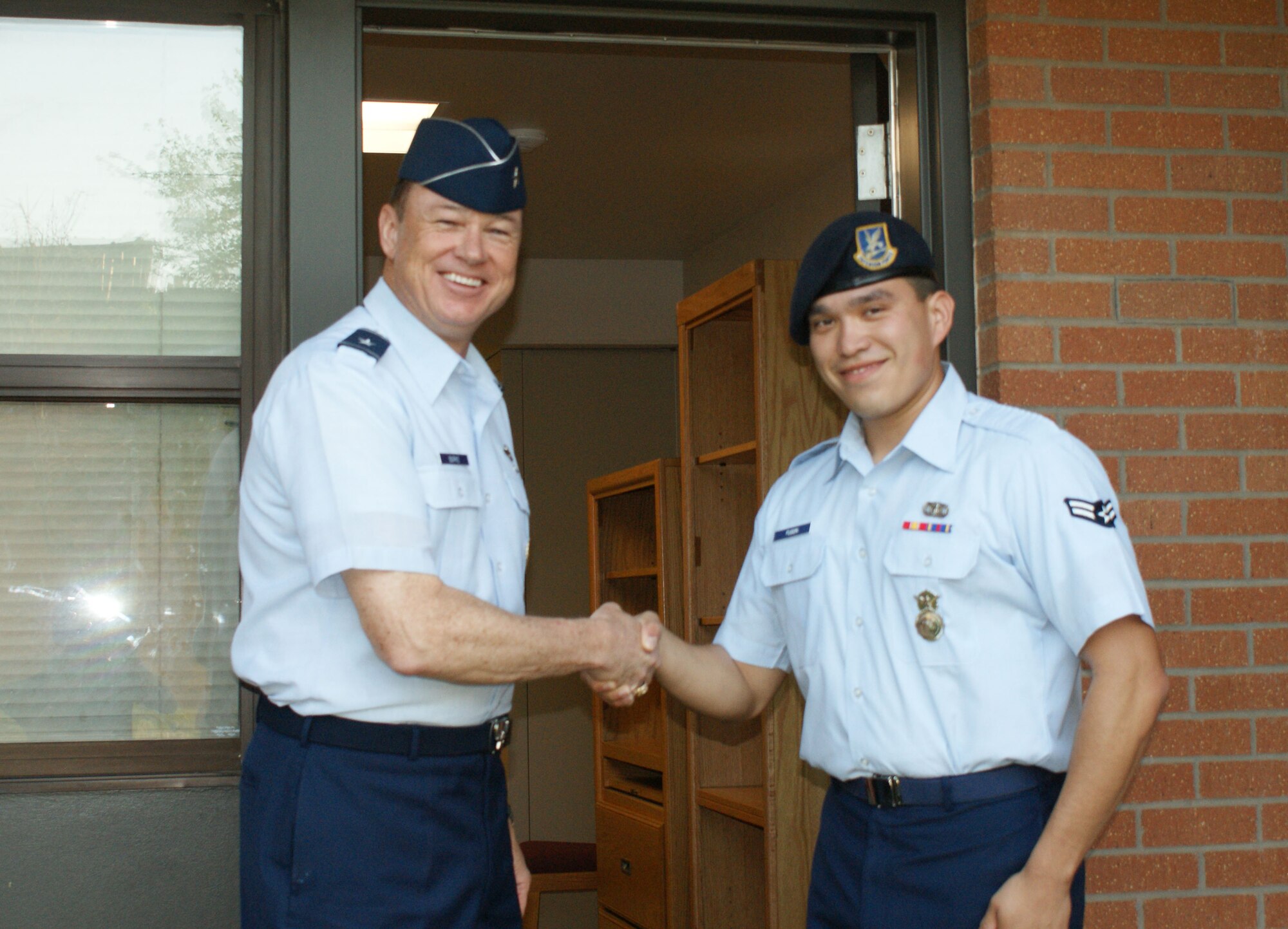 Brig. Gen. Darryl Burke, 82nd Training Wing commander, welcomes Airman 1st Class Isaac Fugon,82nd Security Forces Squadron, to the newly renovated building 527 dormitory during a dedication ceremony Apr. 2, 2012 at Sheppard Air Force Base, Texas.  The renovation project signficantly upgraded the building's air-conditioning system, along with new carpeting, paint and entry key system. (U.S. Air Force photo/Dan Hawkins)