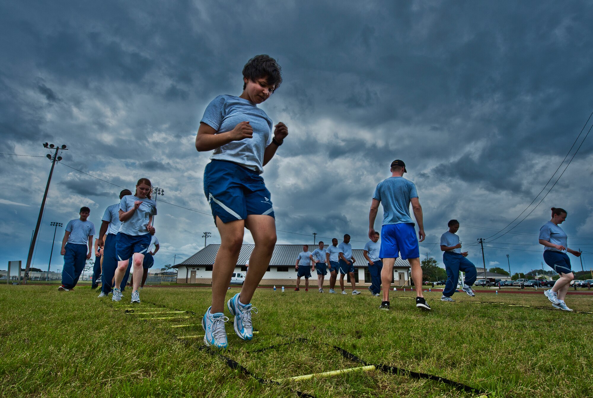More than 20 Airmen perform linear drills during a physical training leader class March 30 at Eglin Air Force Base, Fla.  PTLs lead their flights and squadrons in group PT sessions during the week throughout the base.  (U.S. Air Force photo/Samuel King Jr.)