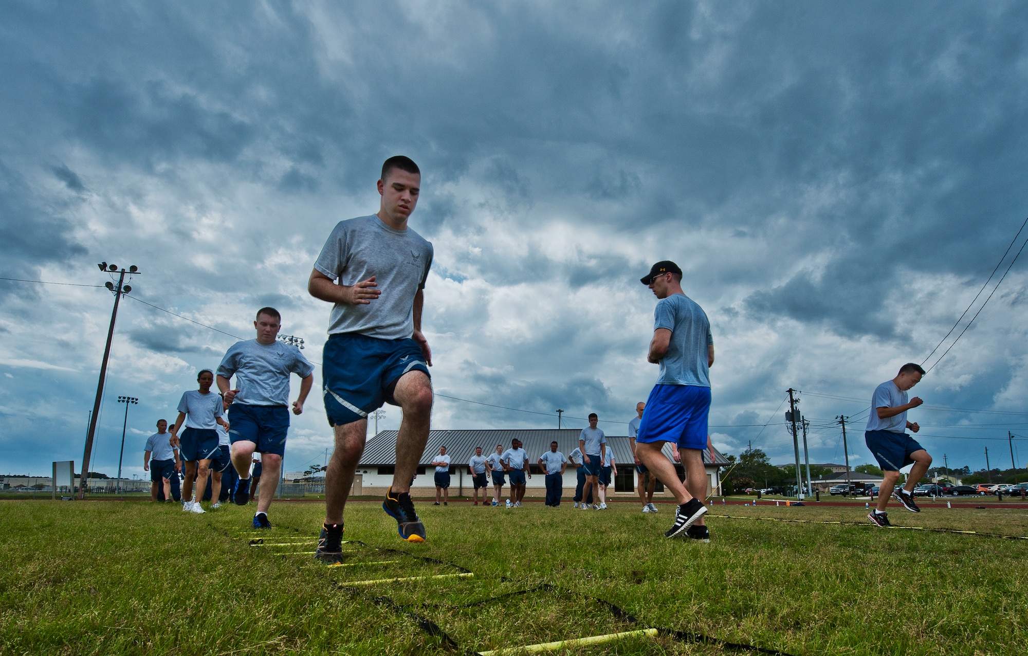 More than 20 Airmen perform linear drills during a physical training leader class March 30 at Eglin Air Force Base, Fla.  PTLs lead their flights and squadrons in group PT sessions during the week throughout the base.  (U.S. Air Force photo/Samuel King Jr.)