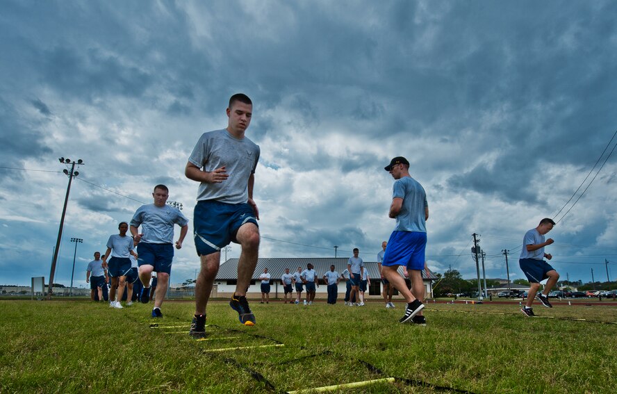 More than 20 Airmen perform linear drills during a physical training leader class March 30 at Eglin Air Force Base, Fla.  PTLs lead their flights and squadrons in group PT sessions during the week throughout the base.  (U.S. Air Force photo/Samuel King Jr.)