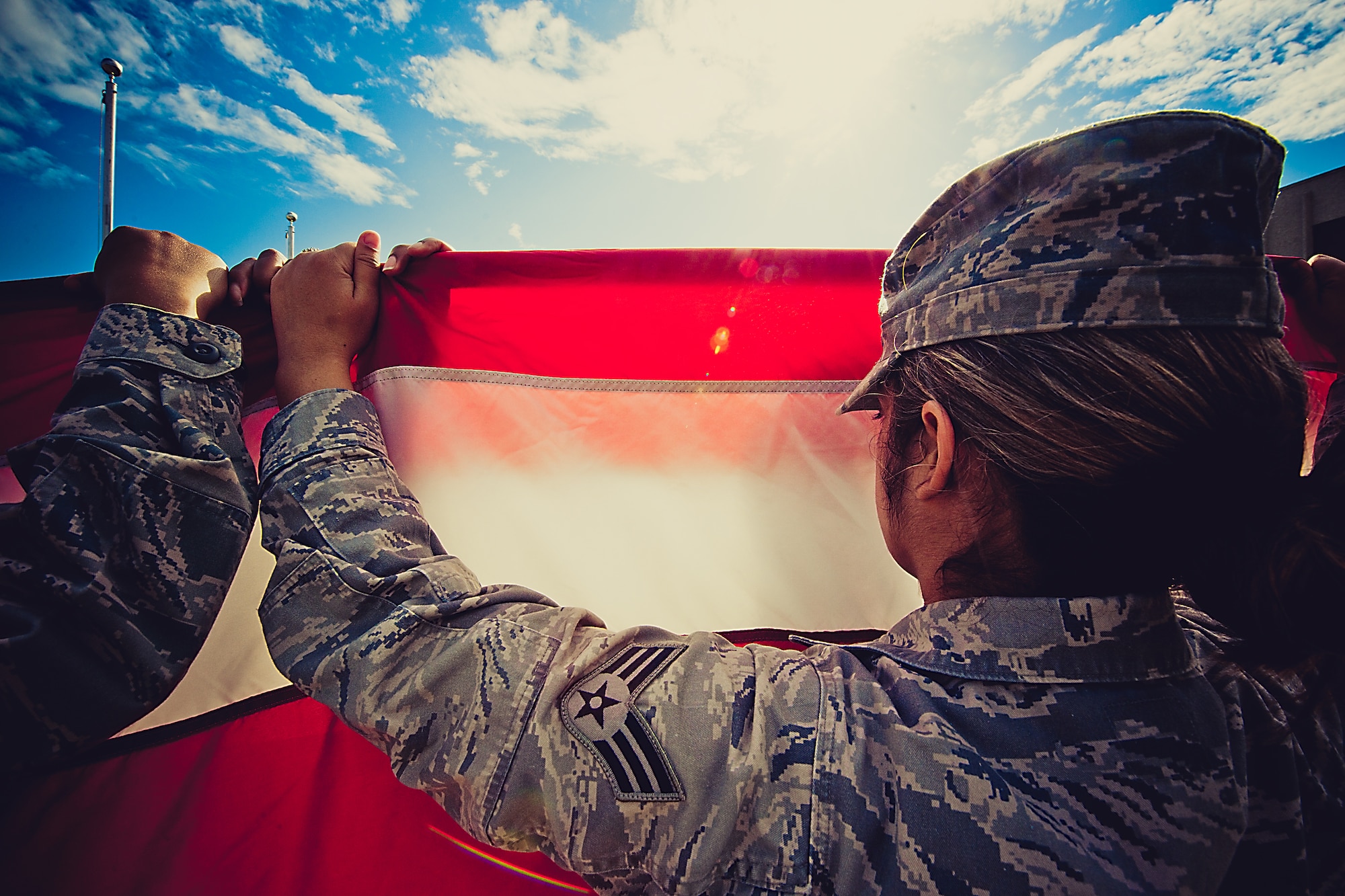 A member of the flag detail holds the flag tightly at the practice prior to the retreat ceremony March 29.  The flag detail and flight positions were filled by women in honor of Women’s History Month.  More than 30 women participated in the ceremony.  To see more photos of the all-women flag detail go to facebook.com/teameglin.  (U.S. Air Force photo/Samuel King Jr.)