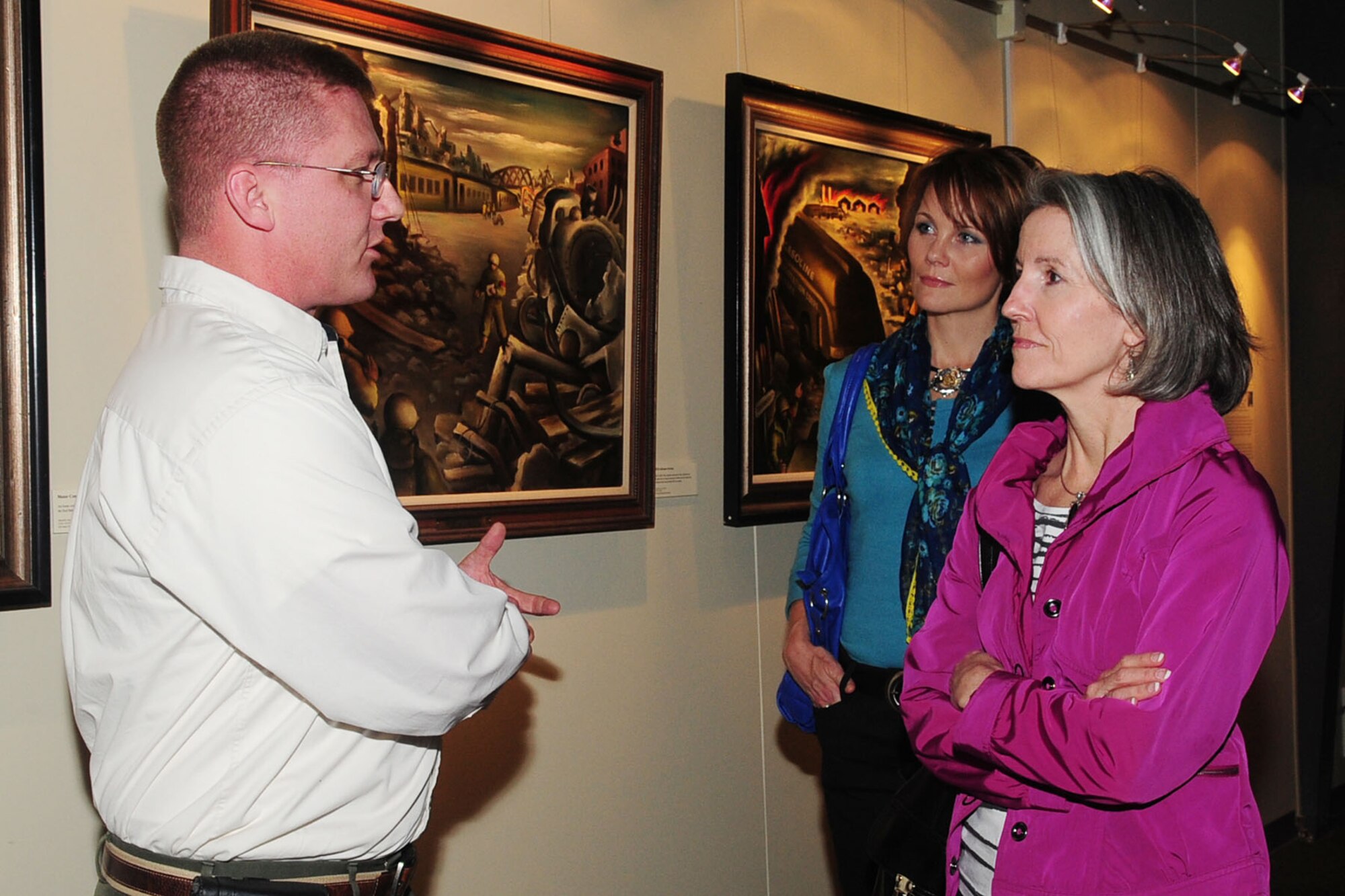 David Hanselman, Eustis Transportation Museum director, gives Kristin Auch, center, wife of U.S. Air Force Col. Korvin Auch, 633rd Air Base Wing commander, and Kathy Hostage, wife of Gen. Mike Hostage, commander of Air Combat Command, a tour of the museum during COMACC’s tour of Joint Base Langley-Eustis at Fort Eustis, Va., March 29, 2012. The commanders’ wives joined them as they toured both installations of JBLE. (U.S. Air Force photo by Staff Sgt. Ashley Hawkins/Released)