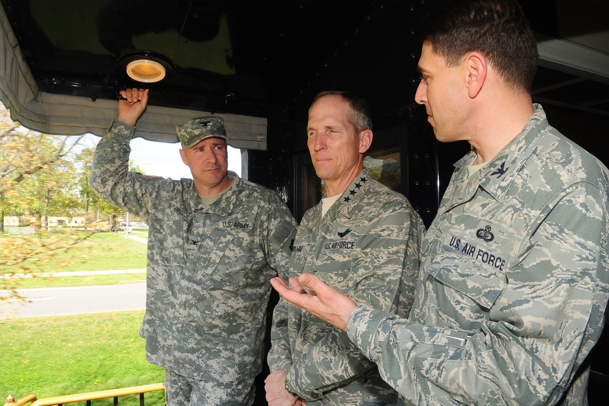 U.S. Army Col. Thomas R. Wetherington, left, 733rd Mission Support Group and Army Support Activity commander, and U.S. Air Force Col. Korvin Auch, right, 633rd Air Base Wing commander, identify significant buildings to Gen. Mike Hostage, commander of Air Combat Command, while taking a train ride at Fort Eustis, Va., March 29, 2012. Hostage visited Joint Base Langley-Eustis to assess the condition of the facilities and personnel. (U.S. Air Force photo by Staff Sgt. Ashley Hawkins/Released)