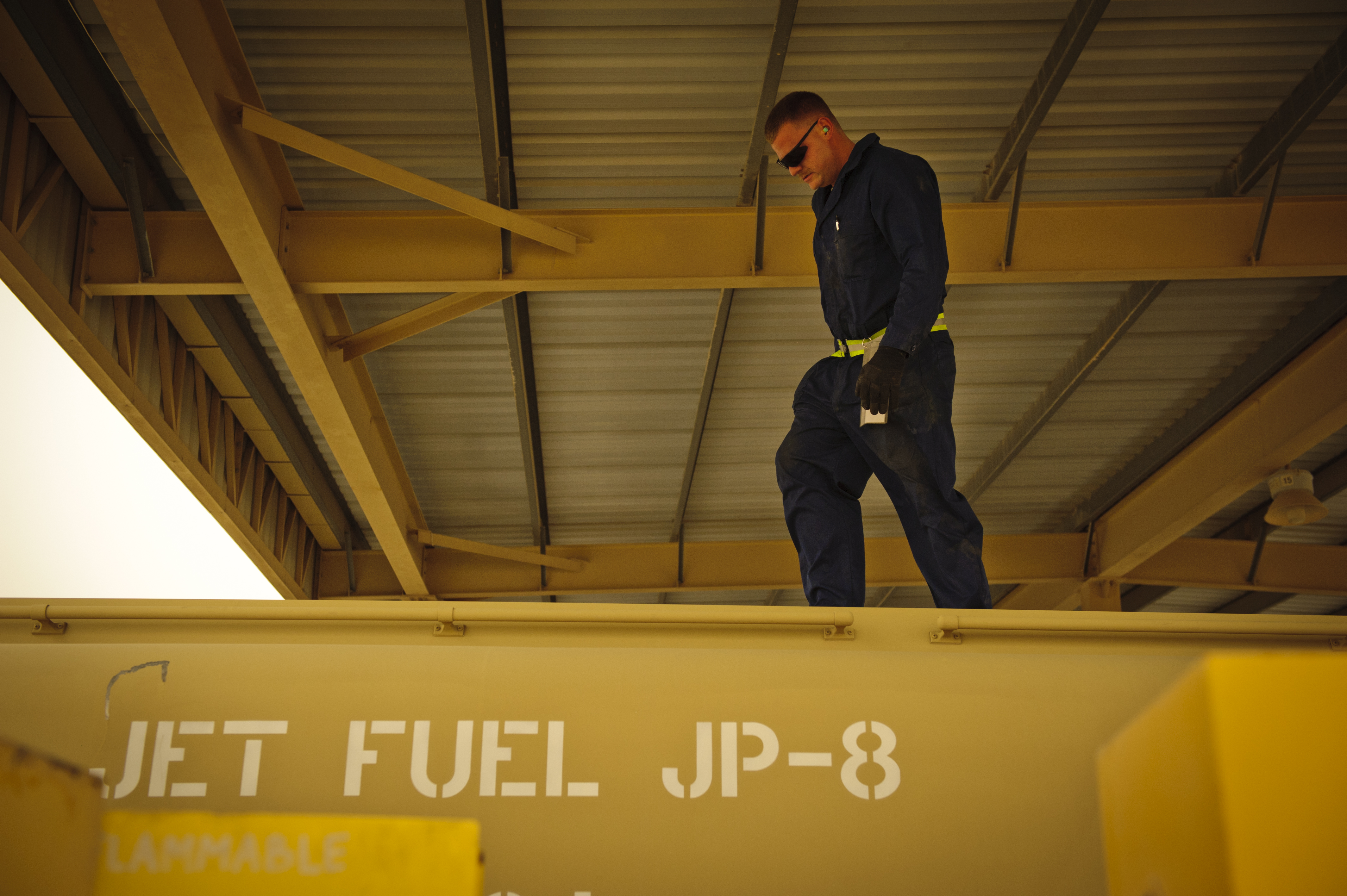 SOUTHWEST ASIA – Staff Sgt. Scottie Thomas, 379th Expeditionary Logistics Readiness Squadron refueling maintenance technician, checks the top of a fuel tank during an inspection here March 30, 2012. The preventative maintenance team inspects the hoses, gauges, and grounding wires, as well as various vehicle functions on every refueling units in their inventory. (U.S. Air Force photo/Staff Sgt. Nathanael Callon)