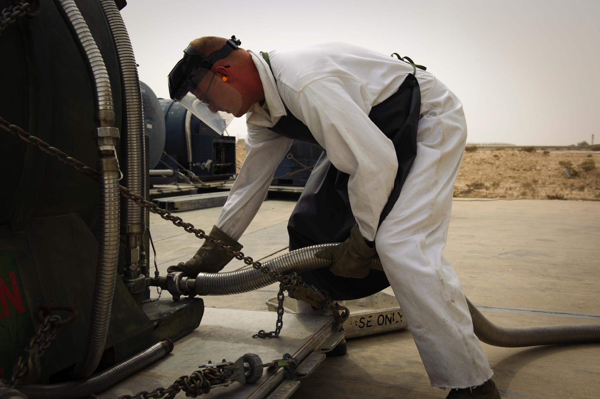 SOUTHWEST ASIA – Staff Sgt. Brandon Wilson, 379th Expeditionary Logistics Readiness Squadron cryogenics supervisor, attaches a hose before filling a tank with liquid oxygen here March 29, 2012. The cryogenics belongs to the 379th ELRS Fuels Flight, and supplies the eleven forward operating bases in the AOR with liquid oxygen and liquid nitrogen. (U.S. Air Force photo/Staff Sgt. Nathanael Callon)
