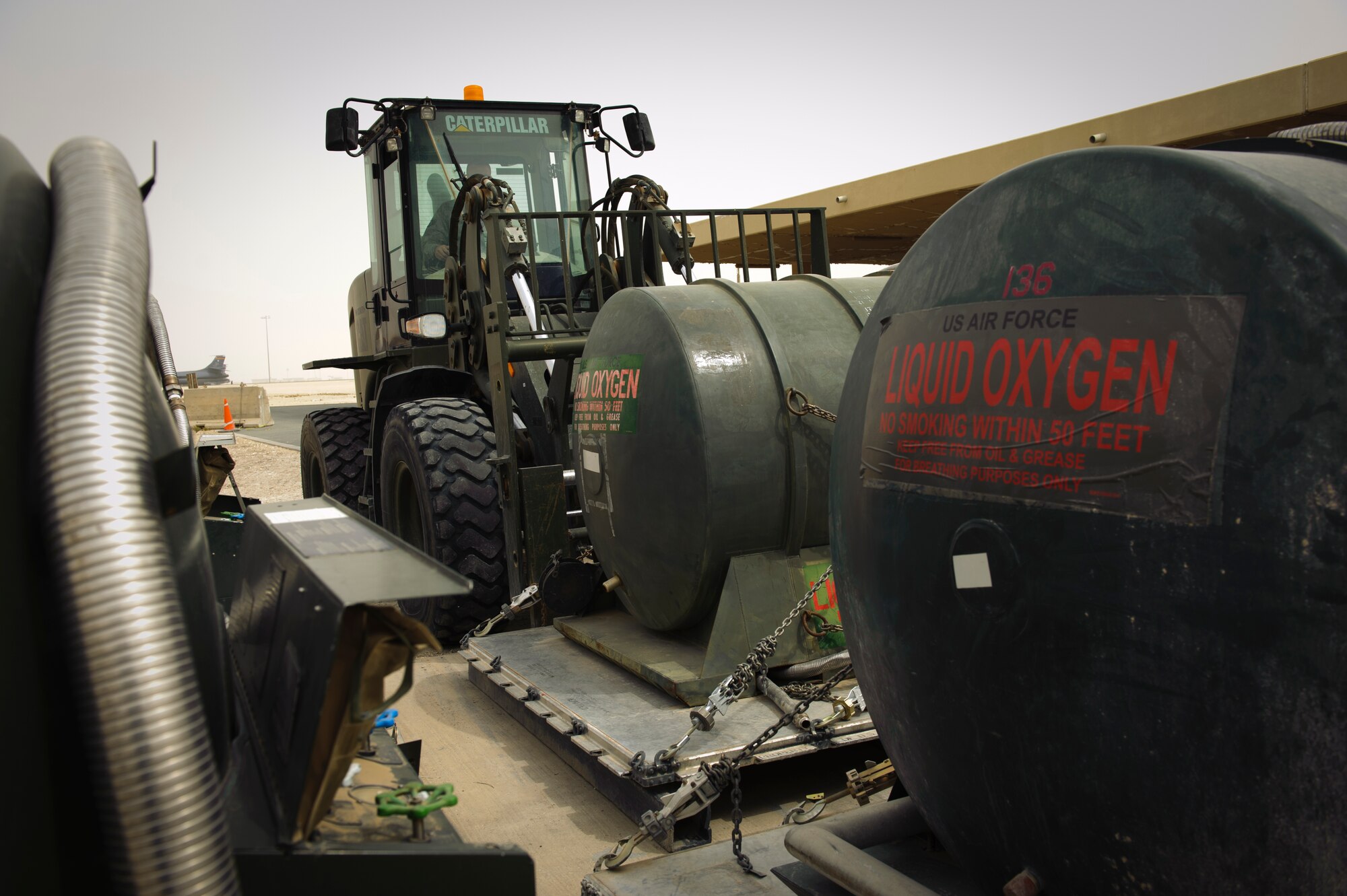 SOUTHWEST ASIA – Staff Sgt. Brandon Wilson, 379th Expeditionary Logistics Readiness Squadron cryogenics supervisor, moves tanks of liquid oxygen in preparation for distribution March 29, 2012. The cryogenics belongs to the 379th ELRS Fuels Flight, and supplies the eleven forward operating bases in the AOR with liquid oxygen and liquid nitrogen. (U.S. Air Force photo/Staff Sgt. Nathanael Callon)