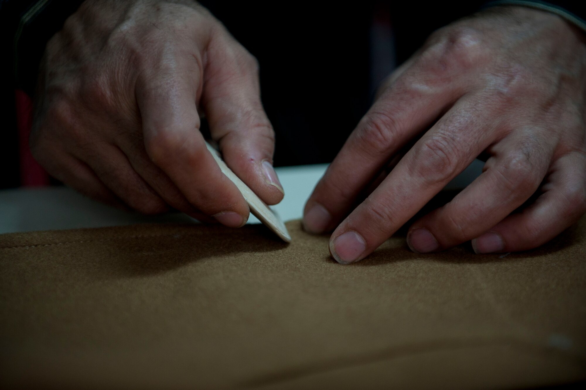 Mehmet Menter, Couzin's Tailor Shop tailor, marks a suit coat for button placement March 29, 2012, in Incirlik Village, Turkey. Menter spent 19 years working in Incirlik Village. (U.S. Air Force photo by Senior Airman Clayton Lenhardt/Released)