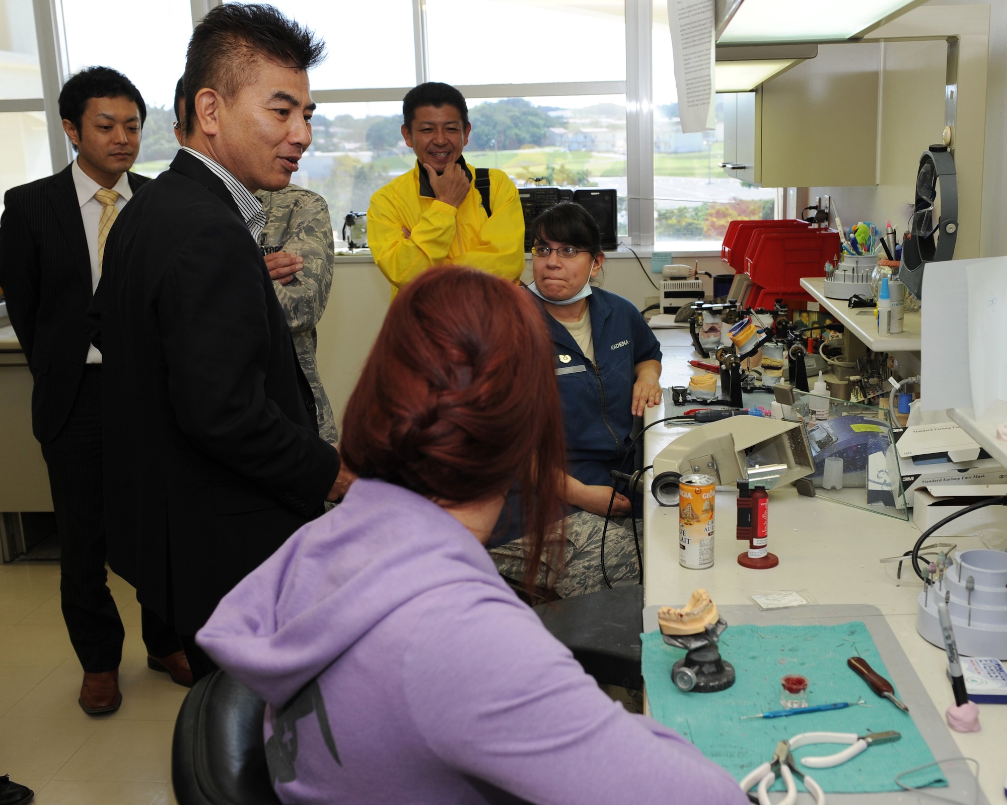 Okinawa Host Nation Dental Providers and the briefers of new machines speak with U.S. Air Force Tech Sgt. Lydia Bee, dental lab technician, and Red Cross volunteer Ms. Sierra Aguilar at the Acrylic room during a half-day seminar on Kadena Air Base, Japan, March 27. The 18th Dental Squadron hosted a half-day seminar with the invitation of the Kadena Air Base Okinawa Host Nation Dental Providers. The seminar kicked off with a mission brief greeting and a tour of the Dental Clinic facility. During the tour, host nation providers were able to exchange medical ideas and get information about the Kadena Dental Clinic system. (U.S. Air Force photo by Junko Kinjo/Released)