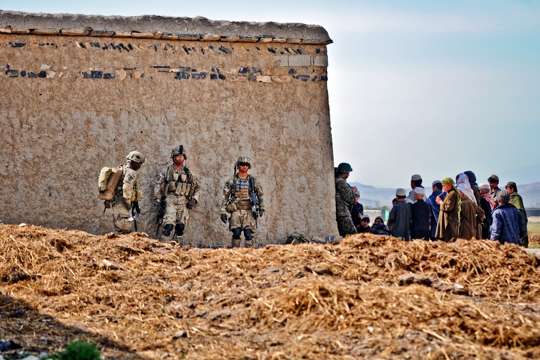 U.S. Army Pfc. Nathan Jackson, left, U.S. Army Spc. Mark Ramirez, center and U.S. Army Sgt. Wilfredo Briones prepare to patrol through the village of Gorchek in Afghanistan's Khowst province, March 30, 2012. Jackson, Ramirez, and Briones are assigned to Company A, 1st Battalion, Airborne, 501st Infantry Regiment.