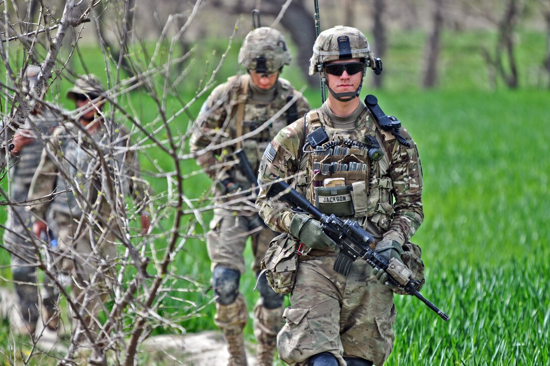 U.S. Army Pfc's. Nathan Jackson, right, and Shelby Beckworth, left, patrol through a field near the village of Gorchek in Afghanistan's Khowst province, March 30, 2012. Jackson and Beckworth are assigned to Company A, 1st Battalion, Airborne, 501st Infantry Regiment.