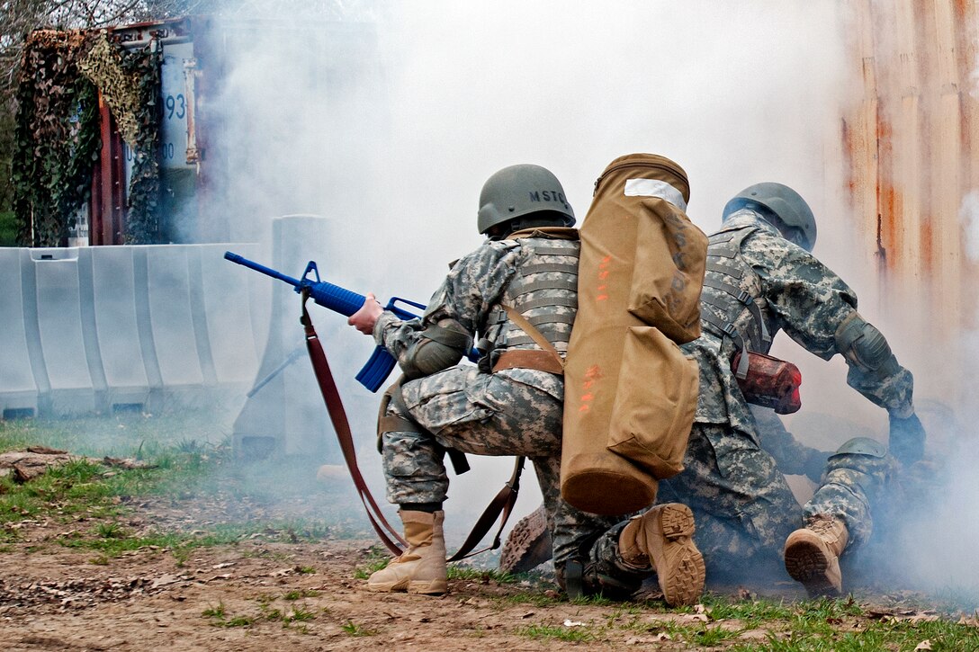 A soldier provides cover support to a simulated casualty while another soldier prepares to help during the physical evaluation portion of the combat lifesaver course on Fort Dix, N.J., March 15, 2012.