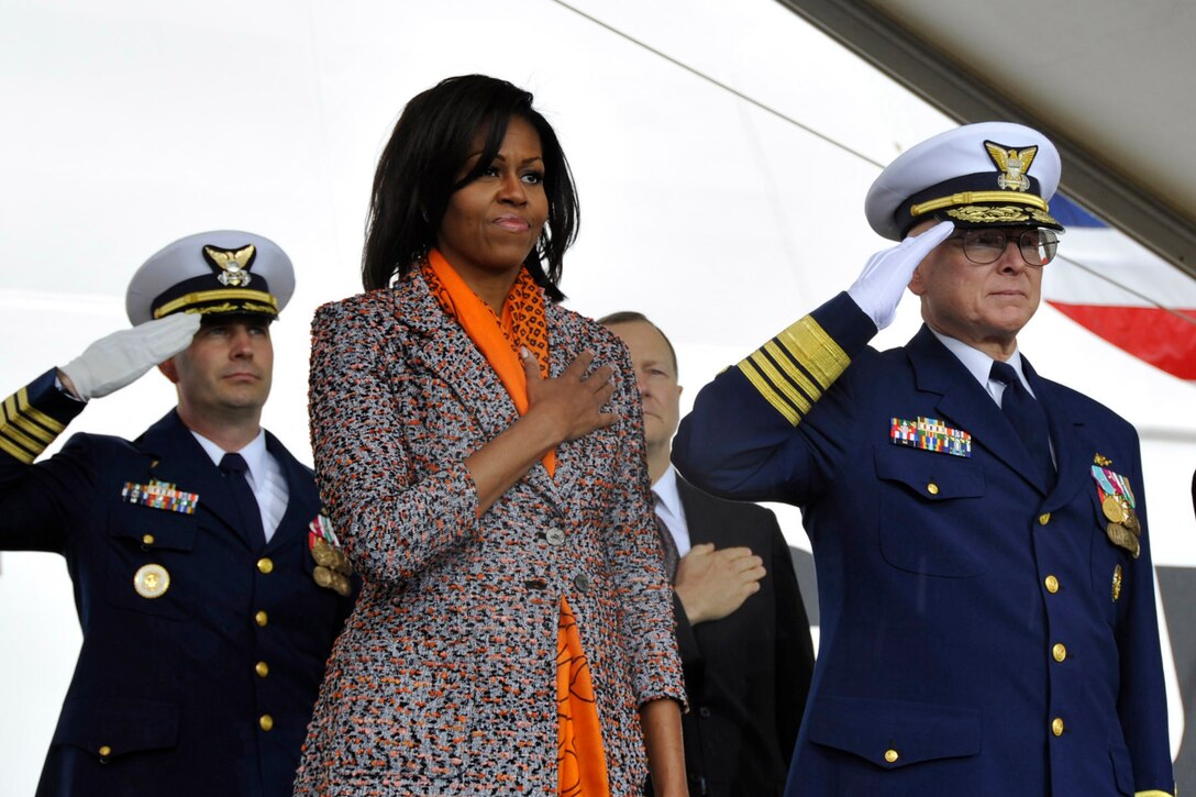 First Lady Michelle Obama covers her heart and U.S. Coast Guard Commandant Robert J. Papp renders a salute during the playing of the national anthem at the commissioning ceremony for  the U.S. Coast Guard Cutter Stratton on Coast Guard Island in Alameda, Calif., March 31, 2012. 