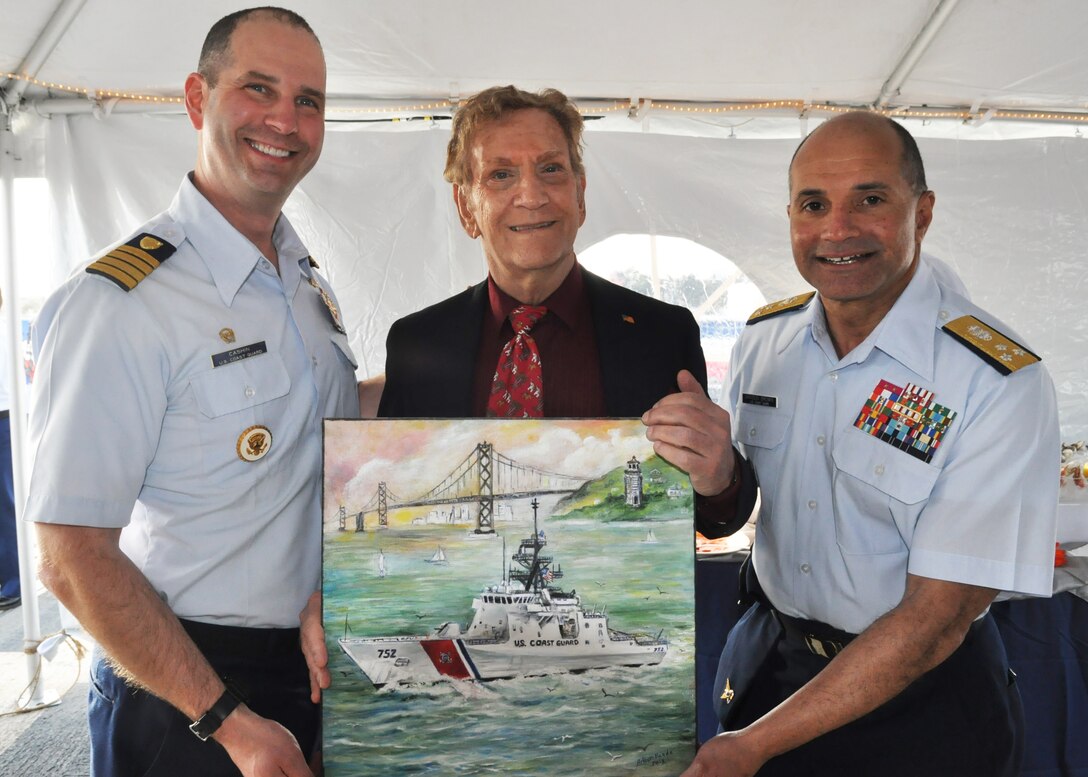 U.S. Coast Guard Capt Charles Cashin, commander of the U.S. Coast Guard Cutter Stratton, and Vice Adm. Manson K. Brown, Pacific Area commander, pose for a photo with Arthur Banda during a reception held aboard the Stratton in Alameda, Calif., March 28, 2012. Banda dedicated more than 40 hours to create an artwork depicting the Stratton steaming through San Francisco Bay and presented it to the ship's crew during the ceremony.  