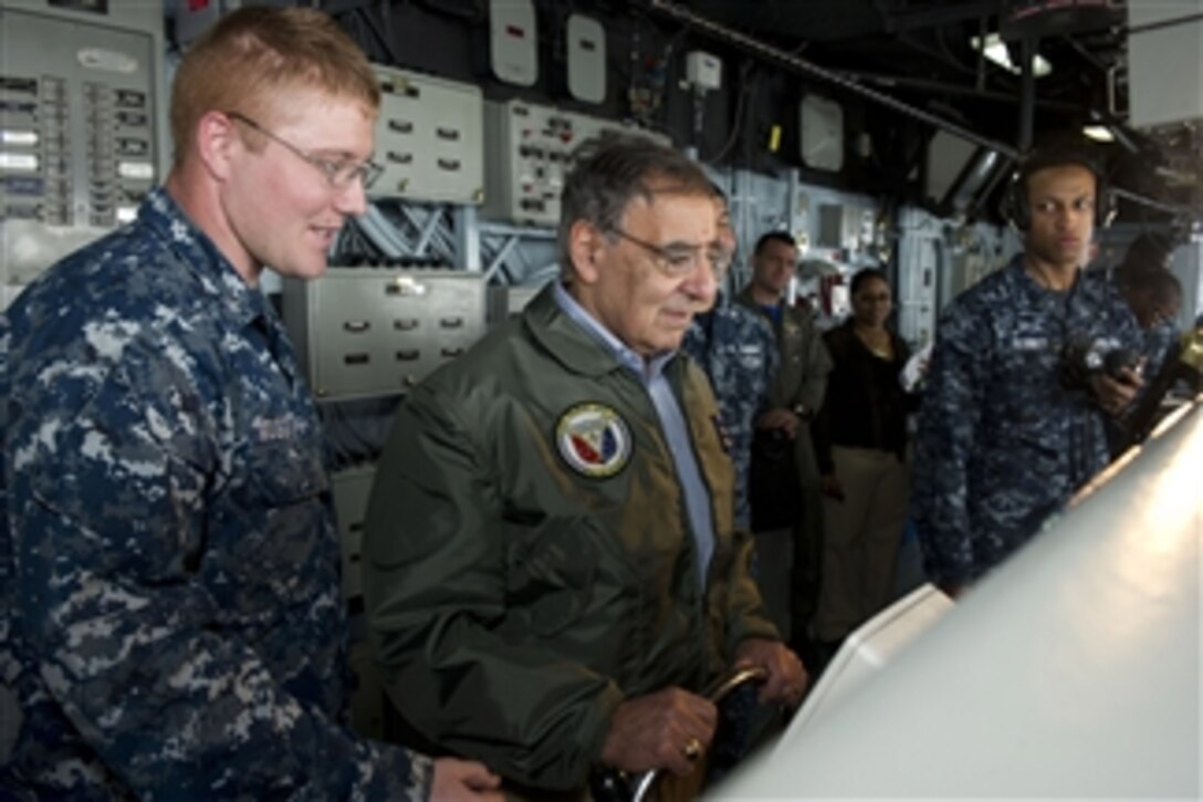 Secretary of Defense Leon E. Panetta steers the USS Peleliu (LHA 5) while on board in the Pacific Ocean off the coast of San Diego, Calif., on March 30, 2012.  Panetta visited several areas on board the ship as well as viewing flight ops on deck.  