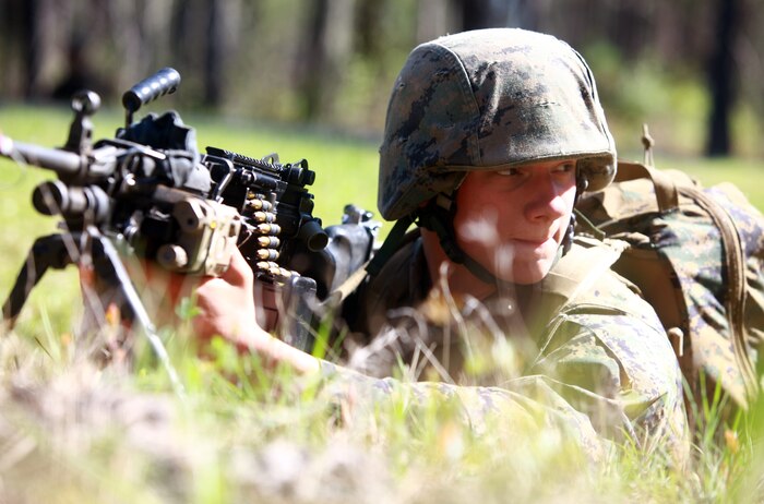 Lance Cpl. Joseph Snyder, a motor transport mechanic with Combat Logistics Regiment 25, 2nd Marine Logistics Group, watches a road as fellow squad members cross it during a field exercise at Gun Position One aboard Camp Lejeune, N.C. April 3, 2012. The purpose of the field exercise was to get the regiment’s Marines and sailors out of their comfort zone and in the field to refresh and enhance basic battle skills they don’t get a chance to practice on a day-to-day basis. (U.S. Marine Corps photo by Pfc. Franklin E. Mercado)