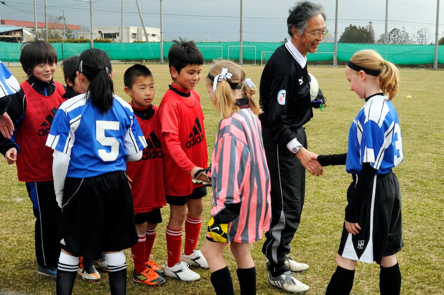 Children from the city of Sendai and Misawa Air Base shake hands and congratulate one another during a joint-youth soccer match at Sendai, Japan, April 1, 2012. The city of Sendai extended an invitation to a Japan-U.S. soccer exchange to children from Misawa Air Base to celebrate the centennial of the Japanese gift of cherry blossoms to the U.S. and form new friendships through the established close ties of their predecessors. (U.S. Air Force photo by 2nd Lt. Son Lee/Released)