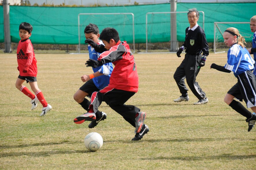 Children from the city of Sendai and Misawa Air Base race to grab a soccer ball during a joint-youth soccer match at Sendai, Japan, April 1, 2012. The children from Misawa Air Base played against the children of Sendai during the first half of the game, and then during the second half of the game, the children were put into mixed teams to encourage joint interaction. (U.S. Air Force photo by 2nd Lt. Son Lee/Released)