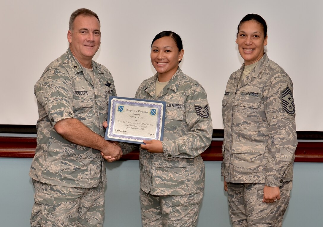 Tech. Sgt. Carrie Cain, 36th Force SupportSquadron professional military education instructor, receives the Air Force level Force Support noncommissioned officer of the  year award from Brig. Gen. John Doucette, March 28. Over the past three years, Sergeant Cain has instructed more than 400 students as an Airman Leadership School instructor. (U.S. Air Force photo by Senior Airman Benjamin Wiseman/Released)
