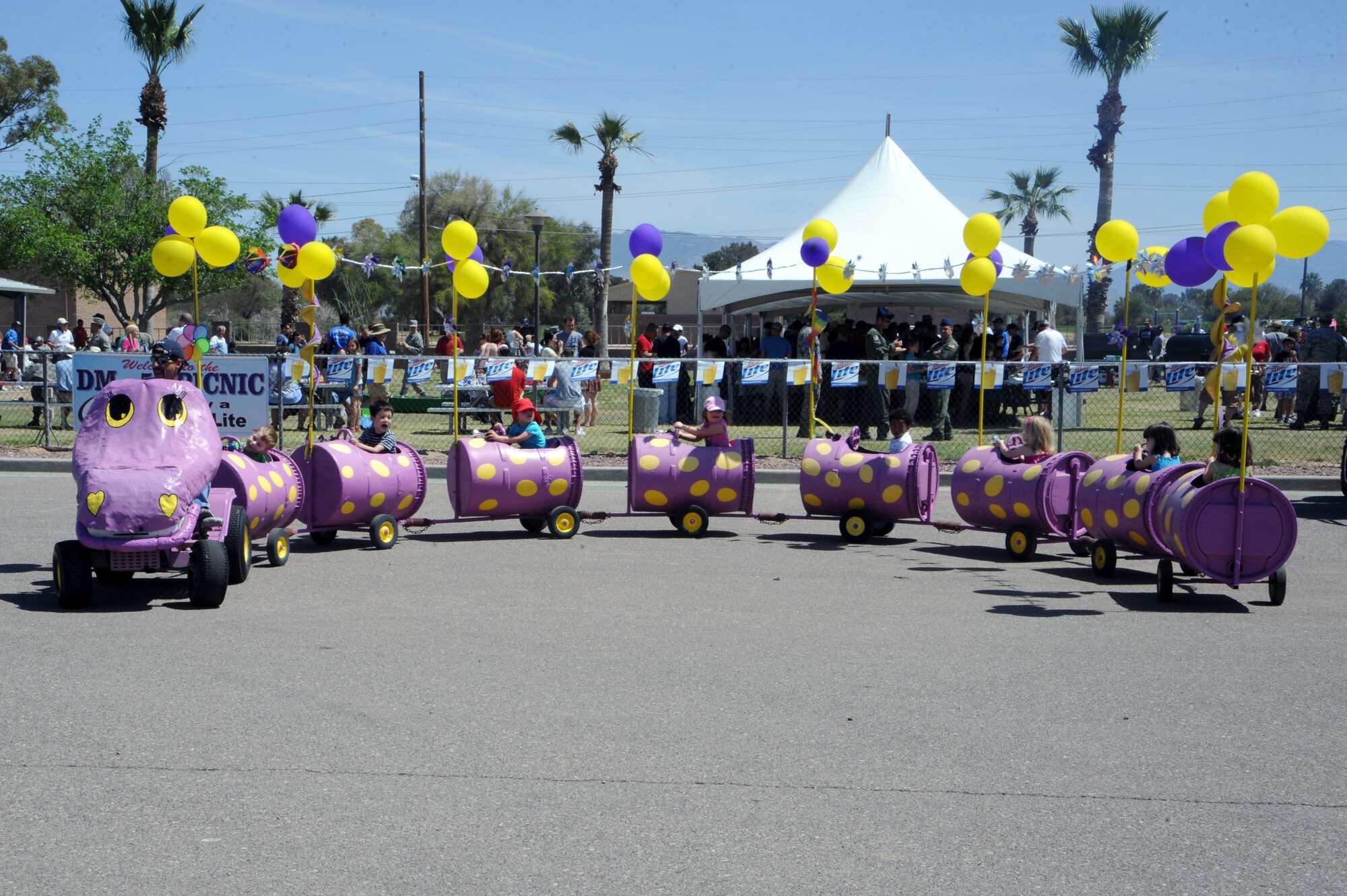 Children enjoy a train ride during the D-M 50 picnic at Davis-Monthan Air Force Base, Ariz., March 31, 2012. The DM-50 hosts the picnic for D-M personnel and their families with free entertainment and food. (U.S. Air Force photo by Airman 1st Class Camilla Griffin/Released)