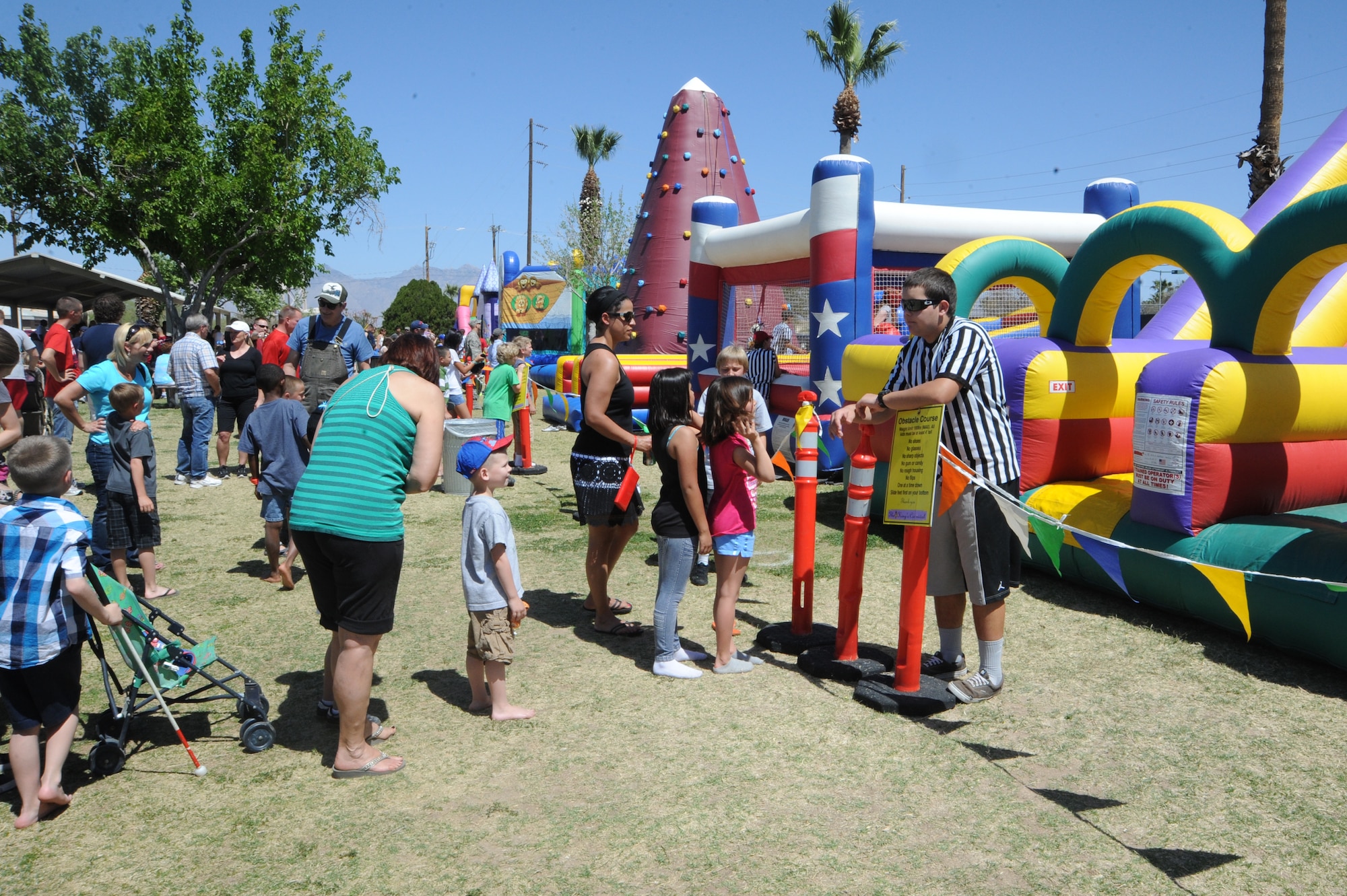 Children wait in line for their turn on an inflatable obstacle course during the D-M 50 picnic at Davis-Monthan Air Force Base, Ariz., March 31, 2012. There were several different activities available to families as well as free food and beverages. (U.S. Air Force photo by Airman 1st Class Camilla Griffin/Released)