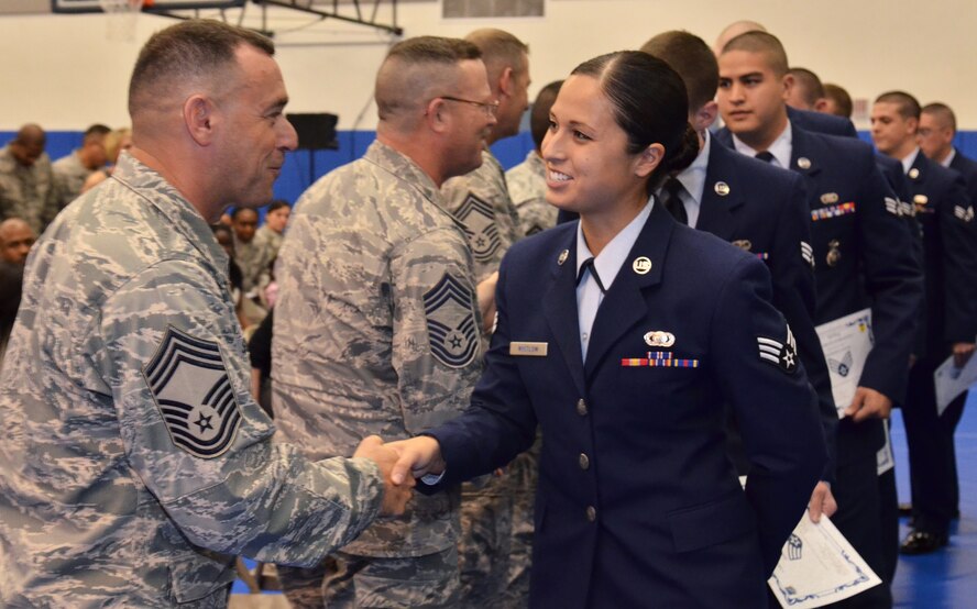 ANDERSEN AIR FORCE BASE, Guam—Senior Airman Mariko Whitlow is congratulated by Andersen’s Chief Master Sgt’s after being promoted below the zone during a Commander’s Call, March 30. Airman Whitlow, 36th Wing Public Affairs, was one of three members to be promoted below the zone at Andersen AFB. The program provides an opportunity for exceptionally well qualified Airmen First Class a one-time consideration for promotion to SrA, to be effective six months prior to the fixed fully-qualified phase point. Selection opportunity is 15 percent of the total time-in-grade and time-in-service eligible population. (U.S. Air Force photo by Senior Airman Benjamin Wiseman/Released)