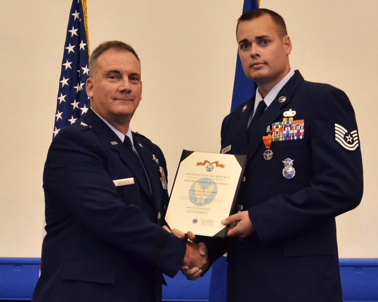 ANDERSEN AIR FORCE BASE, Guam— Tech. Sgt. Joshua Harrison, 36th Security Forces Squadron, receives the Air Force Combat Action Medal from Brig. Gen. John Doucette, 36th Wing commander, during a Commander’s Call, March 30. Sergeant Harrison received the Combat Action Medal for being under direct and hostile fire or physically engaging hostile forces while serving during Operation Enduring Freedom in May 2009. (U.S. Air Force photo by Senior Airman Benjamin Wiseman/Released)