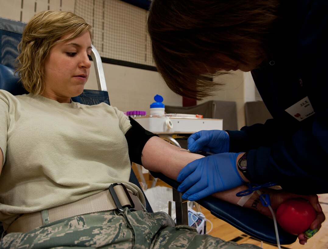 Jullie Nollsch, United Blood Services assistant donor care supervisor, inserts a needle into the arm of Senior Airman Haylley Carlson, 28th Medical Group physical therapy assistant, during a blood drive at Ellsworth Air Force Base, S.D., April 2, 2012. UBS conducts several blood drives throughout the year at a variety of locations. Blood can be stored for only 42 days, so a continual fresh supply is crucial. (U.S. Air Force photo by Airman 1st Class Kate Thornton/Released) 