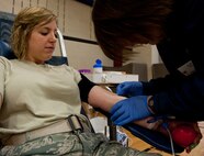 Jullie Nollsch, United Blood Services assistant donor care supervisor, inserts a needle into the arm of Senior Airman Haylley Carlson, 28th Medical Group physical therapy assistant, during a blood drive at Ellsworth Air Force Base, S.D., April 2, 2012. UBS conducts several blood drives throughout the year at a variety of locations. Blood can be stored for only 42 days, so a continual fresh supply is crucial. (U.S. Air Force photo by Airman 1st Class Kate Thornton/Released) 