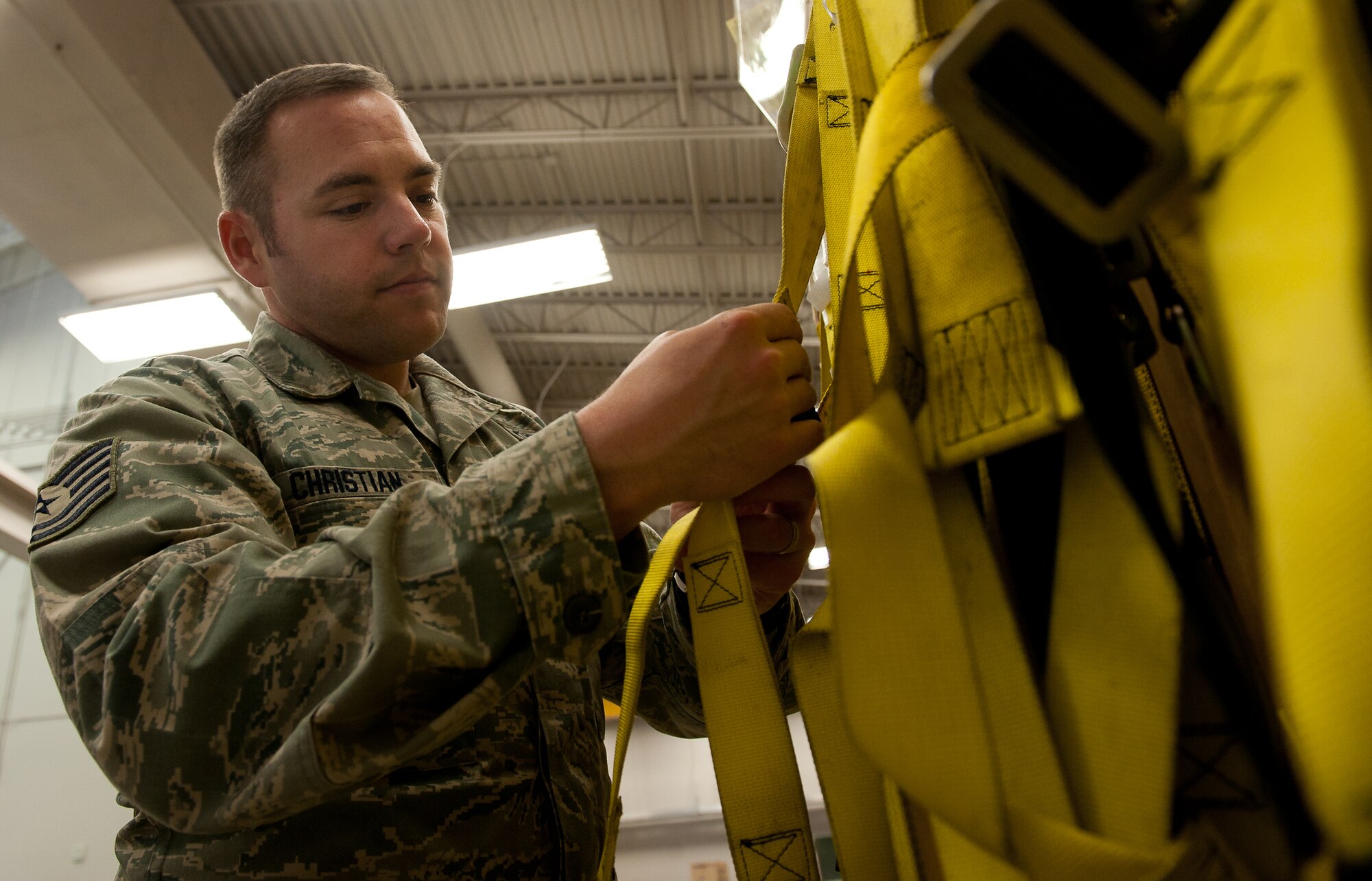 Tech. Sgt. Shane Christian, 28th Bomb Wing Ground Safety NCO in charge, inspects climbing harnesses during a routine safety inspection at the 37th Bomb Squadron support section on Ellsworth Air Force Base, S.D., March 30, 2012. Ground safety specialists are responsible for educating base personnel on risk management, hazard elimination and proper personal protective equipment. (U.S. Air Force photo by Airman 1st Class Kate Thornton/Released)