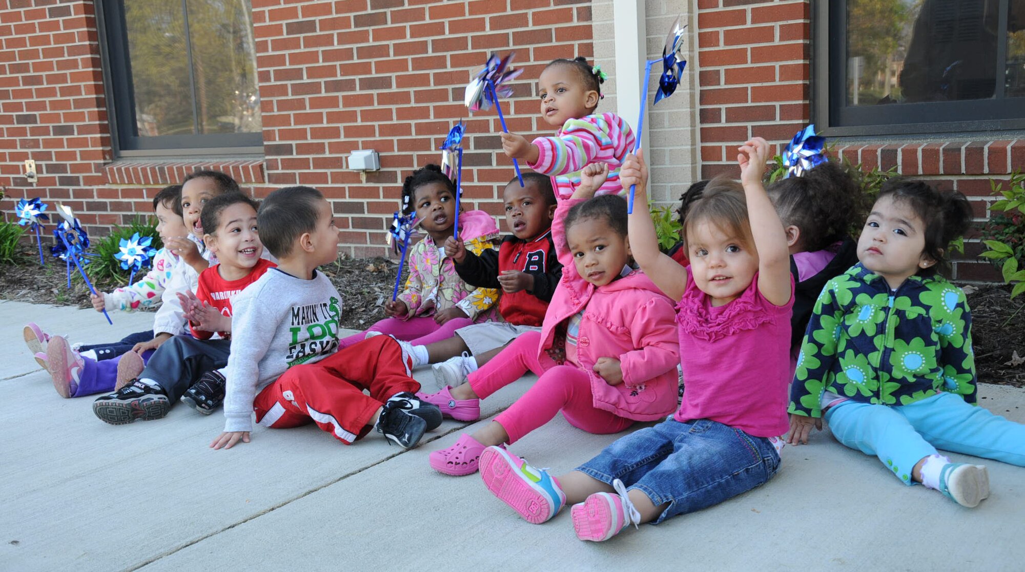 Children from the Fort Eustis Pershing Child Development Center plant pinwheel a garden in recognition of National Child Abuse Prevention Month outside the CDC April 2, 2012. Prevent Child Abuse Virginia introduce the pinwheel as a new symbol for child abuse prevention. (U.S. Air Force photo by Tetaun Moffett/ Released)