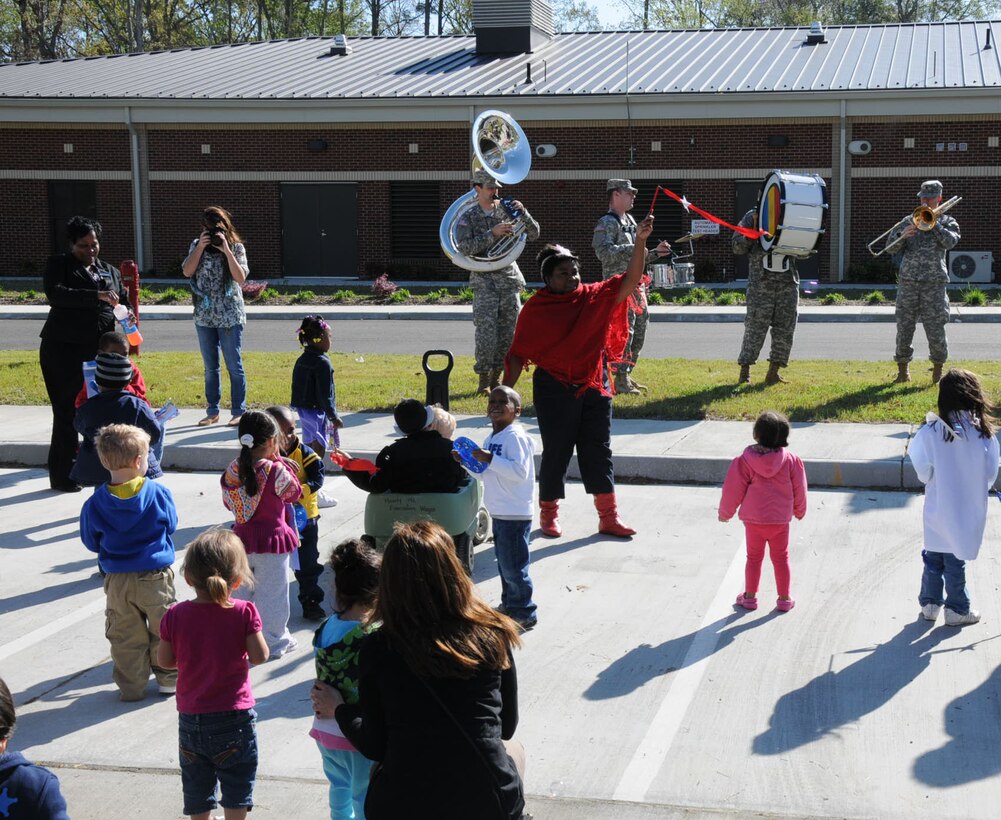 The Army Training and Doctrine Command Band play fun melodies for the children in the parking lot at Fort Eustis Pershing Child Development Center April 2, 2012. The TRADOC Band came out to show their support for National Child Abuse Prevention Month. (U.S. Air Force photo by Tetaun Moffett/ Released)