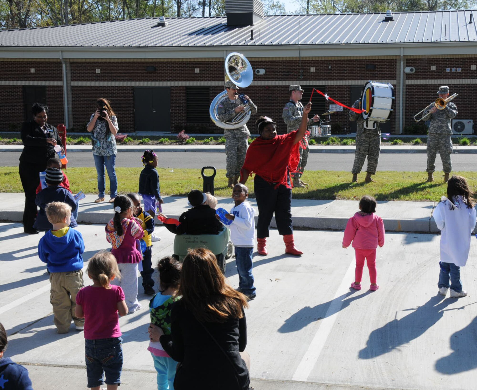 The Army Training and Doctrine Command Band play fun melodies for the children in the parking lot at Fort Eustis Pershing Child Development Center April 2, 2012. The TRADOC Band came out to show their support for National Child Abuse Prevention Month. (U.S. Air Force photo by Tetaun Moffett/ Released)