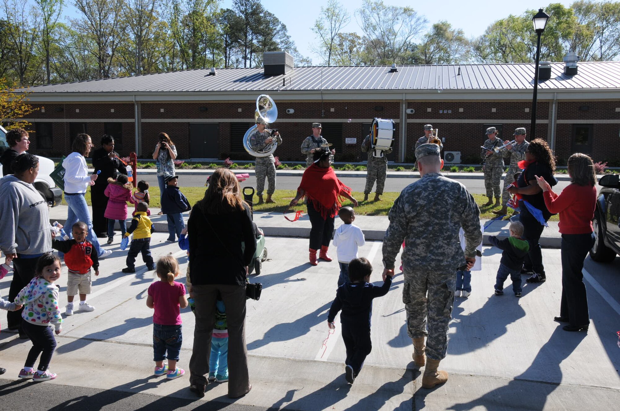 The Army Training and Doctrine Command Band play fun melodies for the children in the parking lot at Fort Eustis Pershing Child Development Center April 2, 2012. The TRADOC Band came out to show their support for National Child Abuse Prevention Month. (U.S. Air Force photo by Tetaun Moffett/ Released)