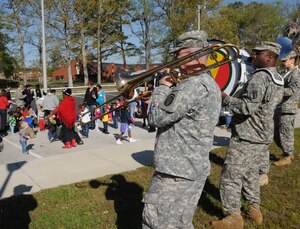 The Army Training and Doctrine Command Band play fun melodies for the children in the parking lot at Fort Eustis Pershing Child Development Center April 2, 2012. The TRADOC Band came out to show their support for National Child Abuse Prevention Month. (U.S. Air Force photo by Tetaun Moffett/ Released)