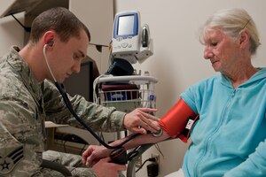 U.S. Air Force Senior Airman Kenneth Kerns, 633rd Medical Operations Squadron medical technician, performs a blood pressure check on Elizabeth Rainville during the Retiree Health Fair March 30, 2012, at Langley Air Force Base, Va.  Retirees 62 and older previously enrolled in TRICARE were eligible to enroll in TRICARE PRIME, receive initial evaluations, medical information and routine health care (U.S. Air Force photo by Senior Airman Stephanie Rubi/Released)