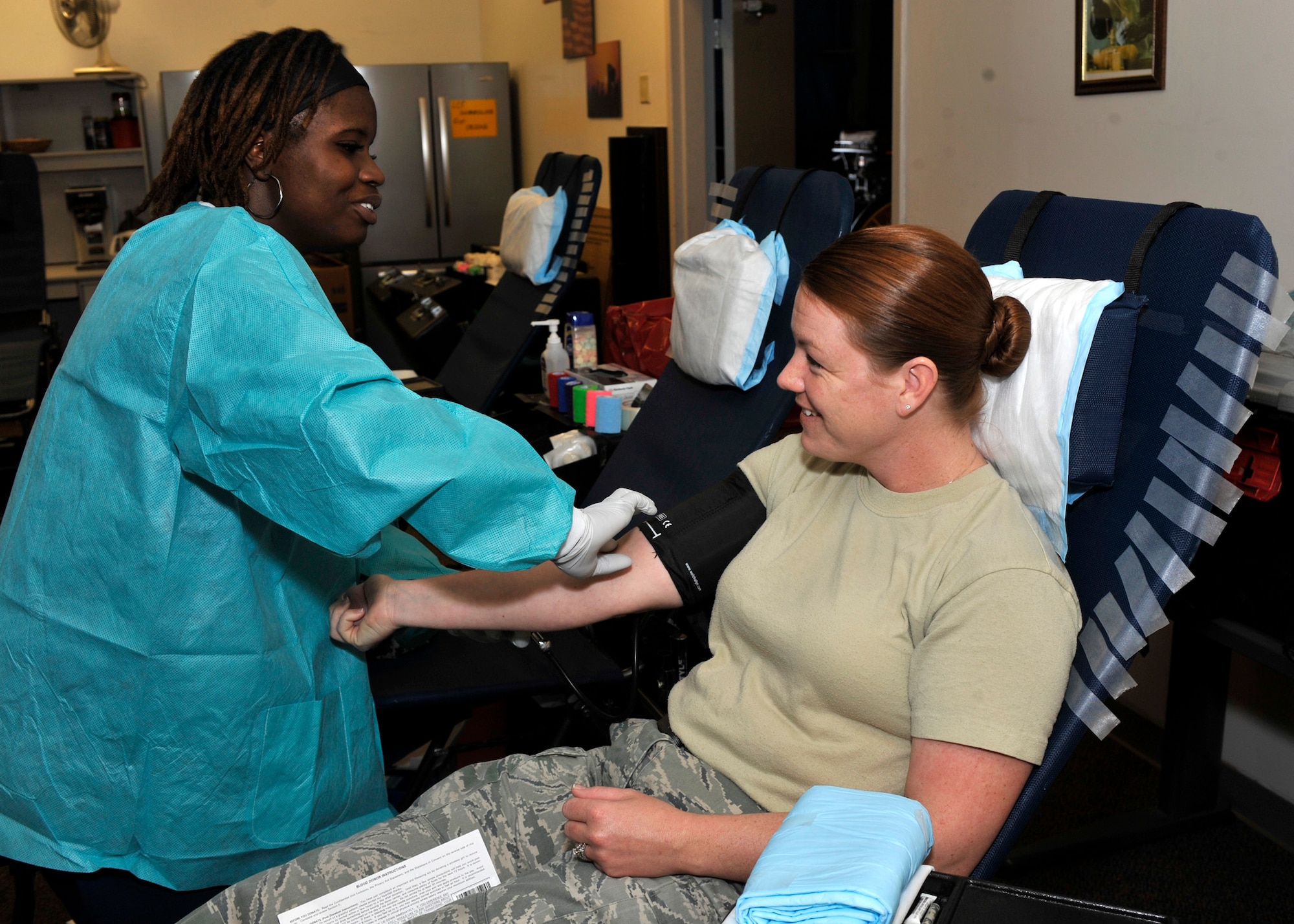 Kimi Campbell, left, prepares to draw blood from Staff Sgt. Ashley Watson, 436th Civil Engineer Squadron, March 29, 2012, at Dover Air Force Base, Del. Watson and dozens of other Team Dover members participated in the blood drive put on by the 436th CES. (U.S. Air Force photo by Tech. Sgt. Chuck Walker)