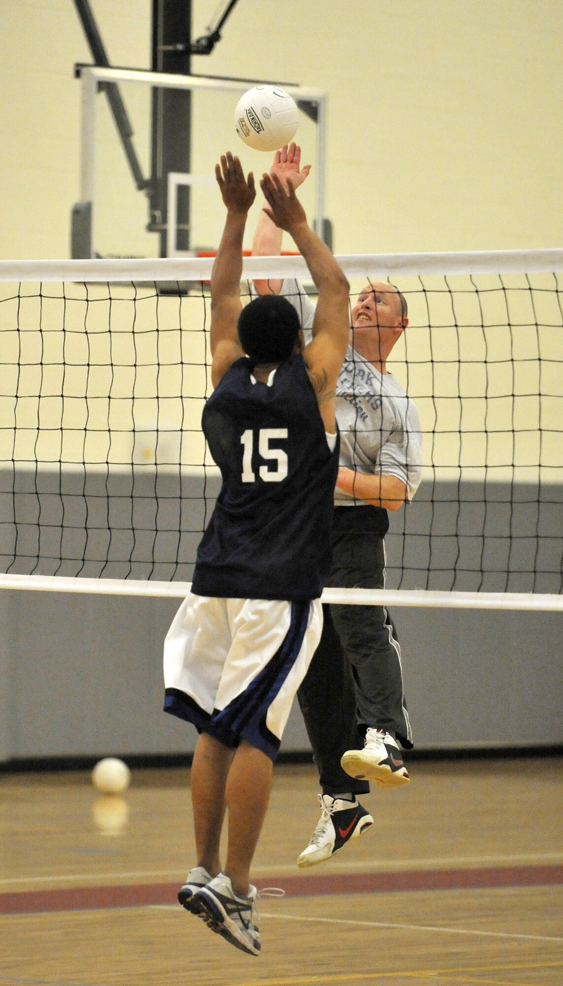 Roger Parsons, 436th Maintenance Squadron B team, right, attempts to slam home a kill as Jason Jones, 736th Aircraft Maintenance Squadron, blocks during an intramural volleyball match April 2, 2012, at Dover Air Force Base, Del. The 436th MXS B team swept the 736th AMXS 25-13 and 25-15 in the first match of the season for both teams. (U.S. Air Force photo by Tech. Sgt. Chuck Walker)