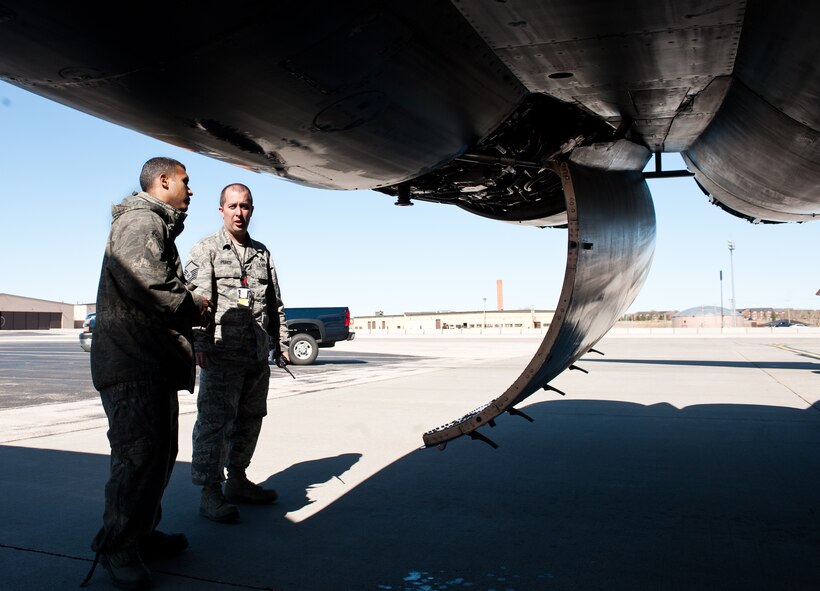 Master Sgt.  Andrew Prakop, 28th Aircraft Maintenance Squadron production superintendent, discusses maintenance work on a B-1 with Staff Sgt. Willy Dominguez, 28th AMXS crew chief, to verify procedures completed at Ellsworth Air Force Base, S.D., March 29, 2012. The production section oversees all scheduled and unscheduled maintenance to ensure aircraft are available to meet mission requirements. (U.S. Air Force photo by Airman 1st Class Alystria Maurer/Released)