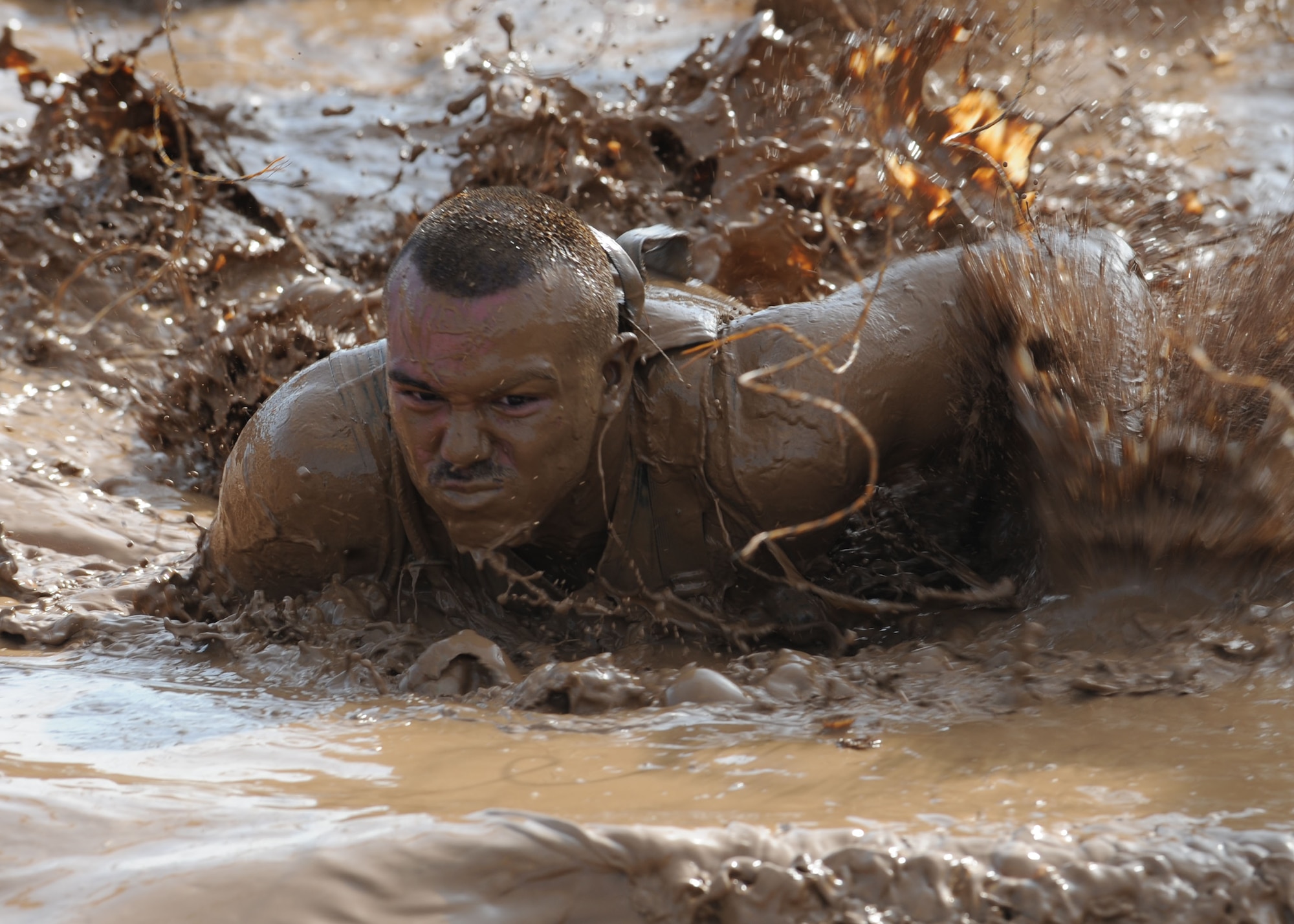 Senior Airman Hossmann Carvajalino, 7th Aerospace Medicine Squadron, completes “Electroshock Therapy,” the final obstacle at the Dallas Tough Mudder event March 31, 2012 in Wortham, Texas. Tough Mudder events are 10-12 mile runs with obstacles designed by British Special Forces to test all around strength, stamina, mental grit and camaraderie. To date, Tough Mudder has raised more than $2,886,000 for the Wounded Warrior Project to aid and assist wounded service members. For more information on locations and events visit http://www.toughmudder.com (U.S. Air Force photo by Airman 1st Class Peter Thompson/Released)