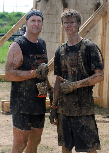 U.S. Air Force Lt. Col. Kevin Seeley, left, 7th Medical Support Squadron commander, and his son Jeremy Seeley, pose together after completing the “Berlin Walls” obstacle at the Dallas Tough Mudder event March 31, 2012 in Wortham, Texas. Tough Mudder events are 10-12 mile runs with obstacles designed by British Special Forces to test all around strength, stamina, mental grit and camaraderie. To date, Tough Mudder has raised more than $2,886,000 for the Wounded Warrior Project to aid and assist wounded service members. For more information on locations and events visit http://www.toughmudder.com (U.S. Air Force photo by Airman 1st Class Peter Thompson/Released)