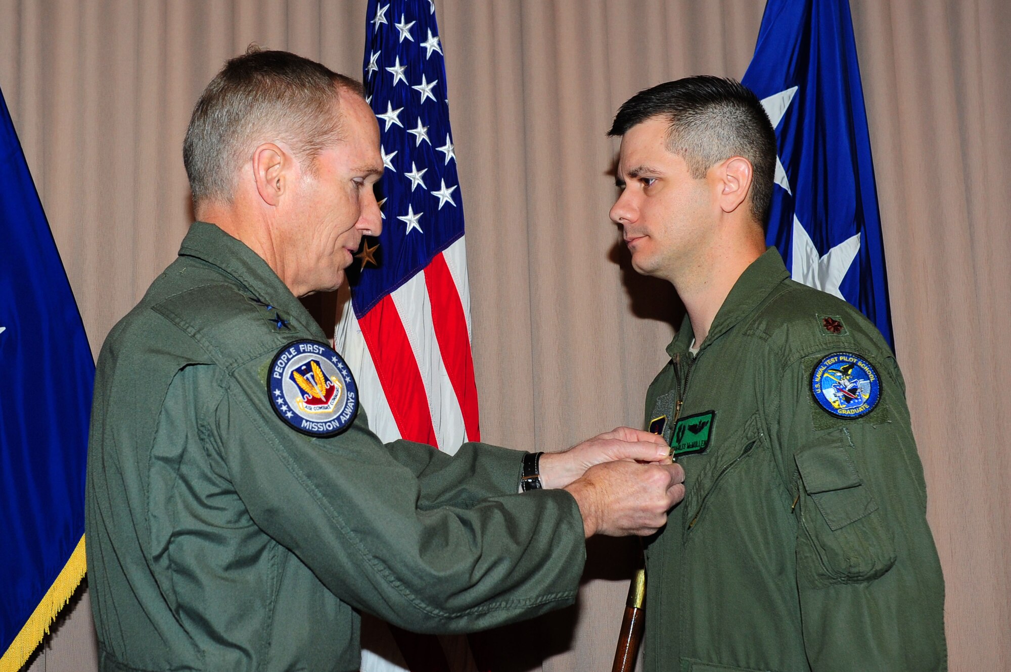 U.S. Air Force Gen. Mike Hostage, commander of Air Combat Command, presents the Silver Star to Maj. Charles McMullen, 41st Rescue Squadron helicopter pilot, at Langley Air Force Base, Va., April 3, 2012. McMullen received the Silver Star after leading an aerial combat rescue mission in Afghanistan Dec. 28, 2009, during which his team came under fire from insurgents from a nearby village.  (U.S. Air Force photo by Airman 1st Class Kayla Newman/Released)