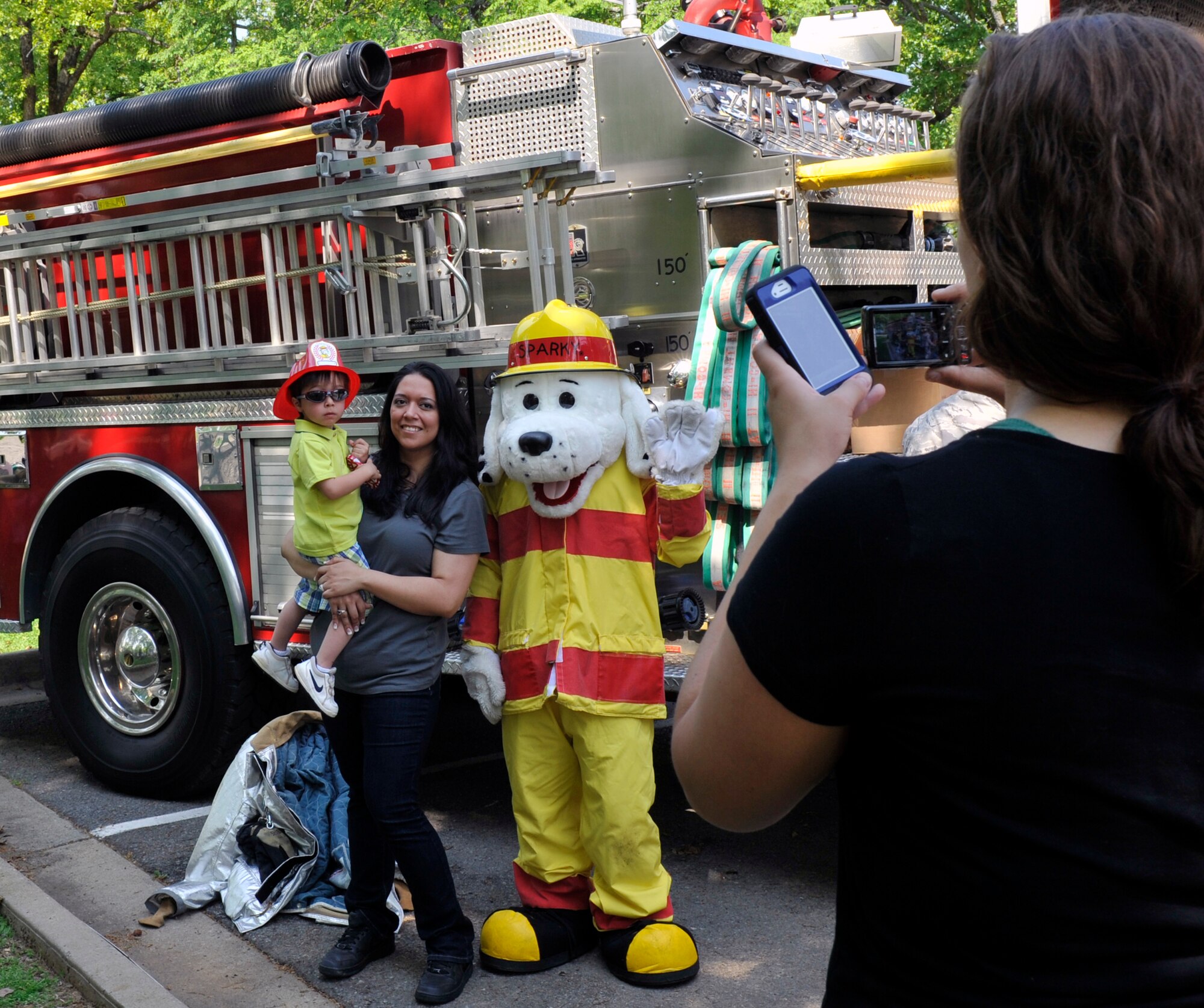 A Team Little Rock family poses with Sparky the mascot, during Family Fest, March 31, 2012, at Little Rock Air Force Base, Ark. Sparky is the mascot for the 19th Civil Engineering Squadron fire department. (U.S. Air Force photo by Airman 1st Class Rusty Frank)