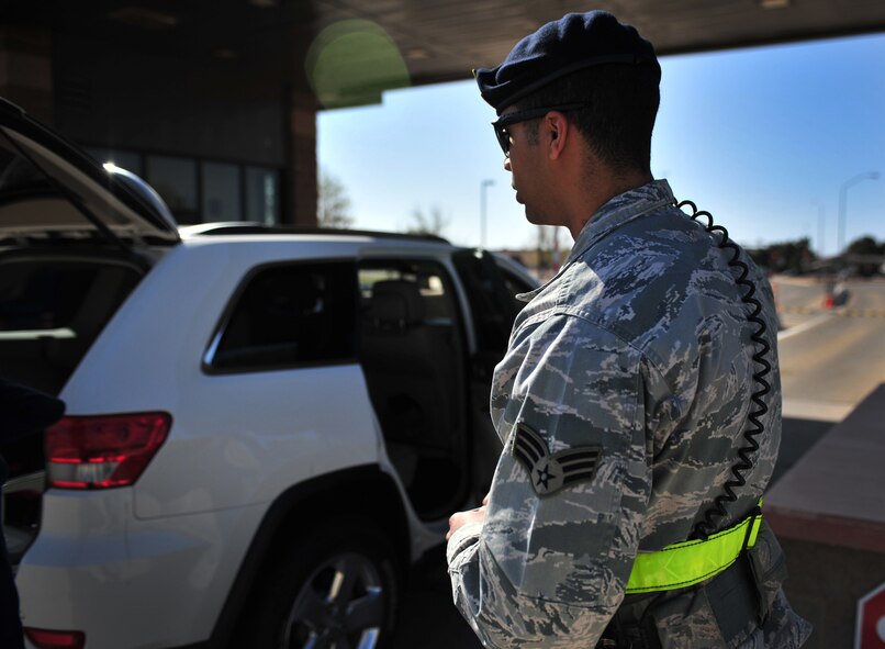 U.S. Air Force Senior Airman Victor Rodriguez, 27th Special Operations Security Forces Squadron patrolman, posts at the main gate to perform random vehicle inspections at Cannon Air Force Base, N.M., March 27, 2012. Security forces troops ensure the safety of all Air Commandos, families and visitors. (U.S. Air Force photo by Airman 1st Class Alexxis Pons Abascal) 