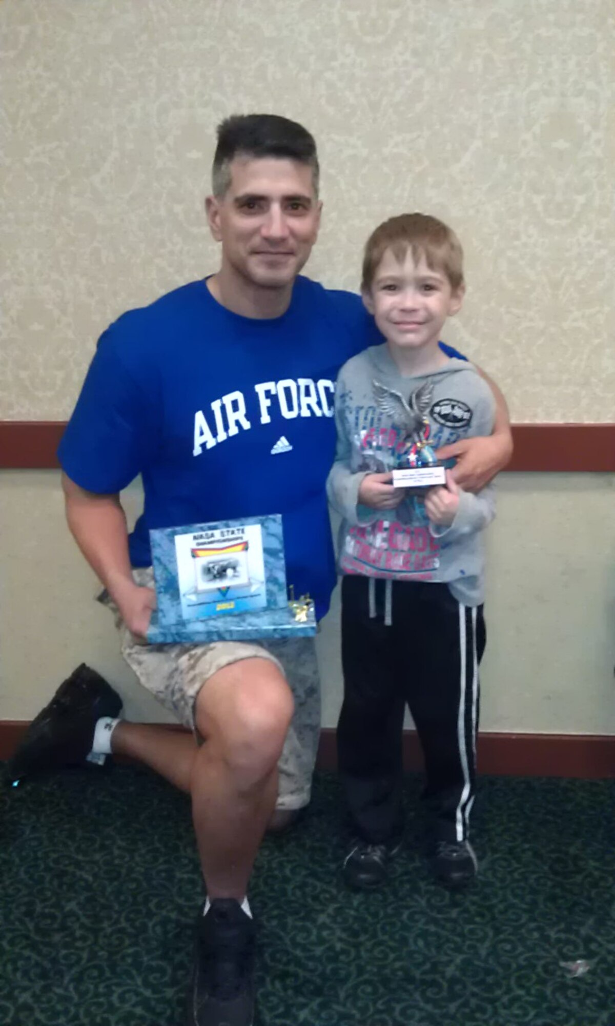 DALLAS, Texas - Lt. Col. Michael Jones, 17th Logistics Readiness Squadron Commander poses with his son Tony after winning first place in the "pure," meaning lifetime steroid free category, and the over age 40 category, at the Natural Athlete Strength Association sponsored Powerlifting Championship, March 10. (Courtesy Photo)



