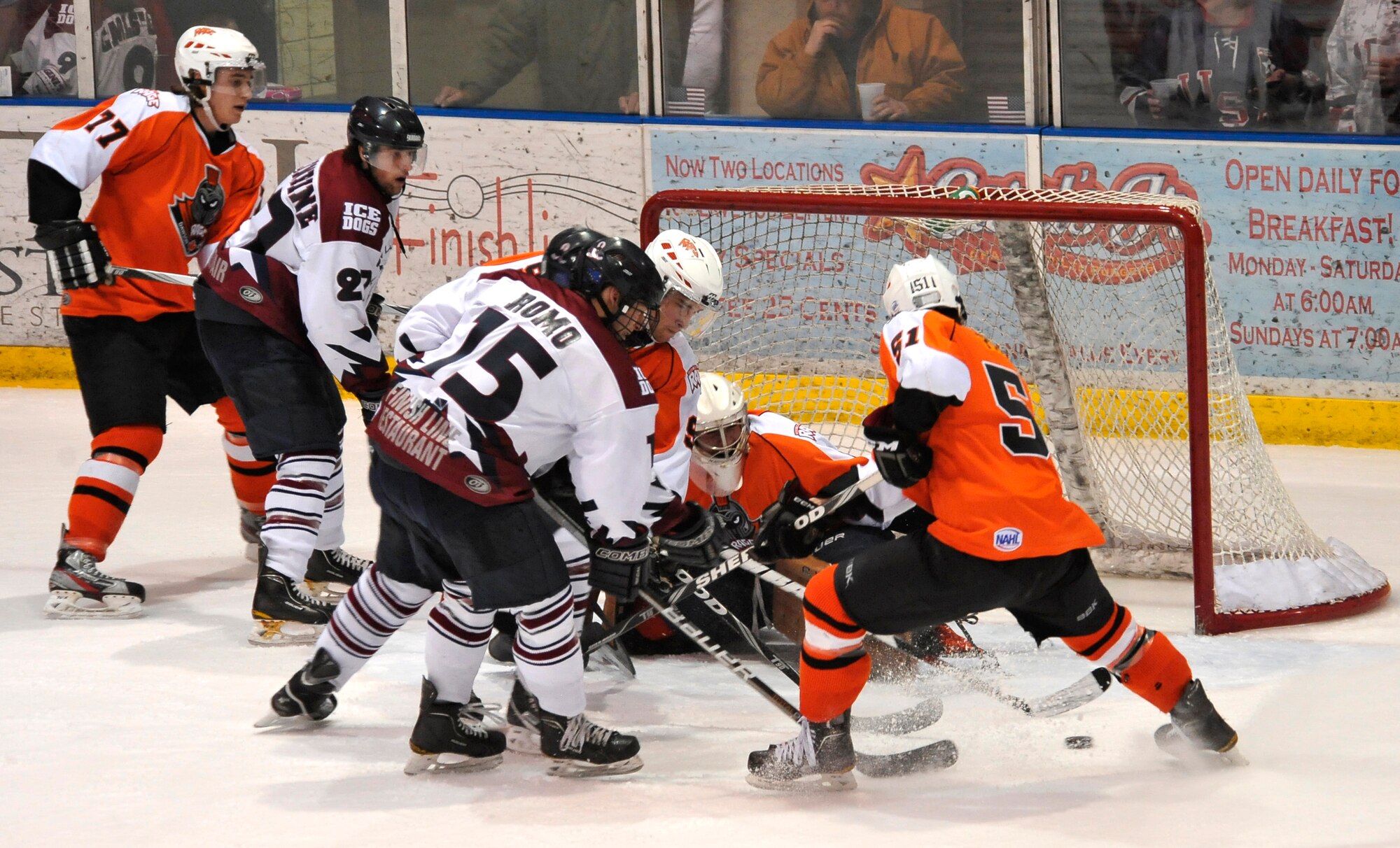 A crowd of Fairbanks Ice Dogs attempt to score against the Dawson Creek Rage goalie during a Military Appreciation game against the Dawson Creek Rage at the Big Dipper Arena, March 30, 2012, Fairbanks, Alaska.  (U.S. Air Force photo/Staff Sgt. Miguel Lara III)