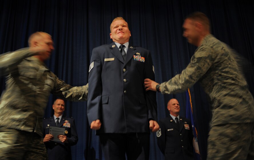 Newly promoted U.S. Air Force Staff Sgt.  Kyle Detwiler, 23d Equipment Maintenance Squadron, receives his new rank during Team Moody’s promotion ceremony at Moody Air Force Base, Ga., April 2, 2012. It is an Air Force custom for coworkers or family members to present promotion stripes to new promotees. (U.S.  Air Force photo by Airman 1st Class Doug Ellis/Released)